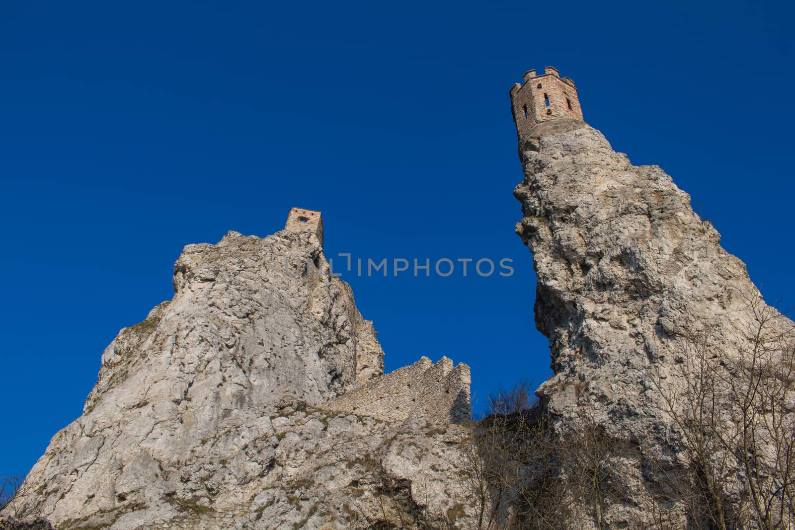 Castle Devin built on the high rocks on the border of Slovakia and Austria. On the left famous Maiden Tower. Bright blue sky.