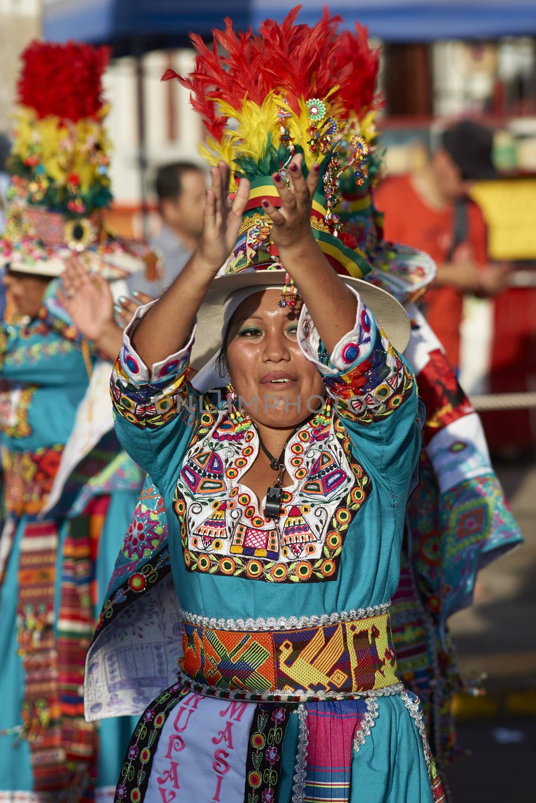 Tinku dancing group in colourful costumes performing a traditional ritual dance as part of the Carnaval Andino con la Fuerza del Sol in Arica, Chile.