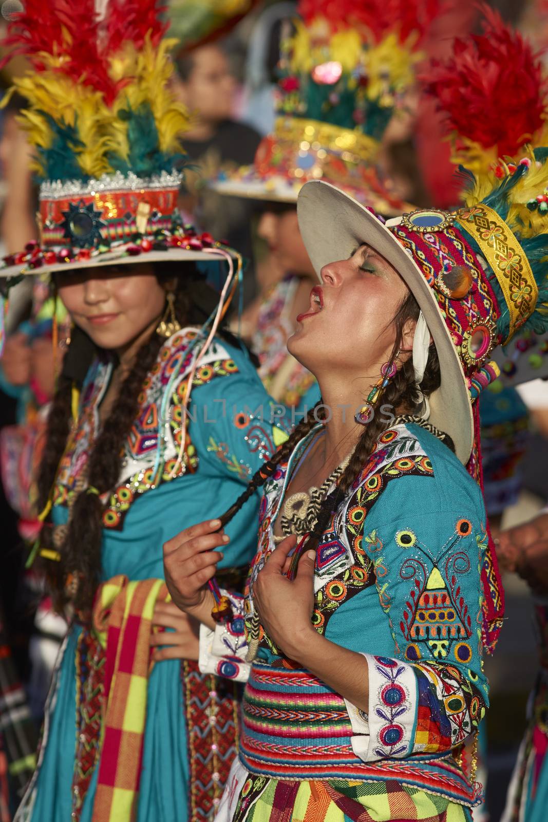 Tinku dancer in colourful costume singing whilst performing a traditional ritual dance as part of the Carnaval Andino con la Fuerza del Sol in Arica, Chile.