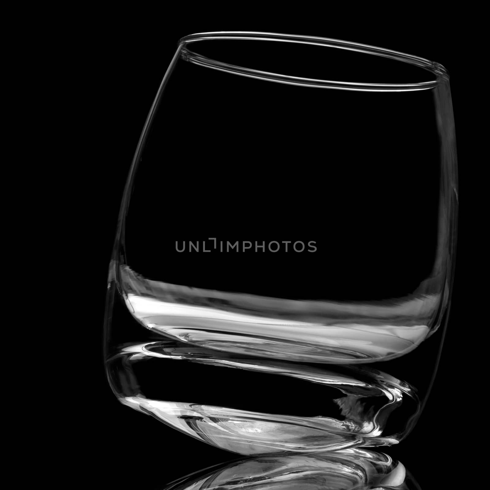 For a glass of whiskey on black background is not filled by Gaina