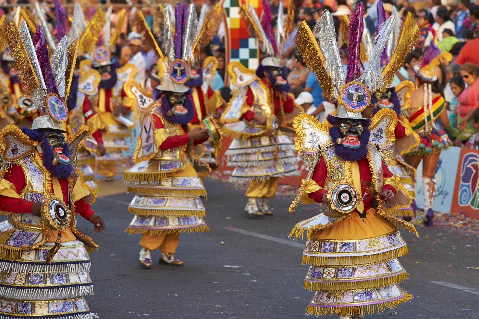 Morenada dance group in traditional Andean costumes performing at the annual Carnaval Andino con la Fuerza del Sol in Arica, Chile.