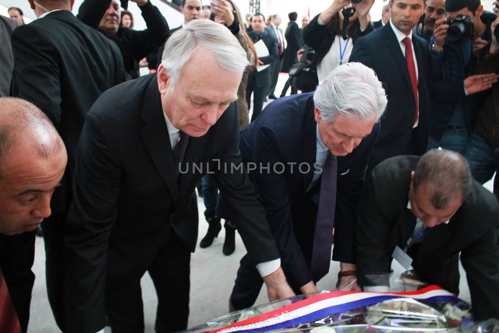 TUNISIA, Tunis: French Foreign Minister Jean-Marc Ayrault helps unveil a memorial at Bardo National Museum on March 18, 2016 for the one-year-anniversary of the terror attack there. The assault by Islamic State militants left 24 people dead that day in 2015.