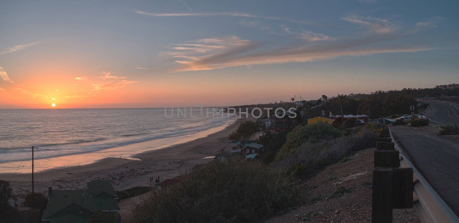 Cottages along Crystal Cove Beach, on the Newport Beach and Laguna Beach line in Southern California at sunset with a rainstorm looming.