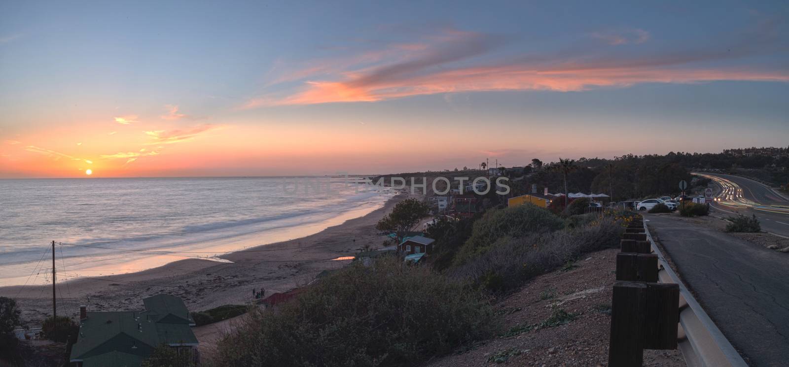 Cottages along Crystal Cove Beach, on the Newport Beach and Laguna Beach line in Southern California at sunset with a rainstorm looming.