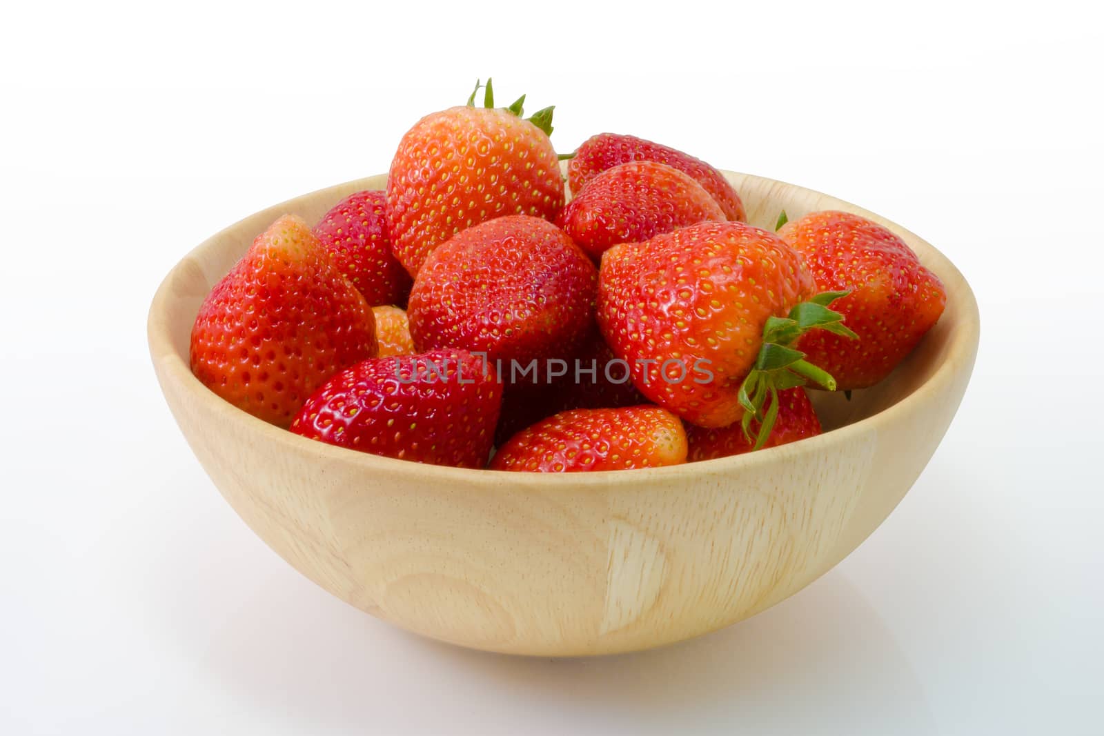 fresh strawberry in wooden bowl isolated on white background
