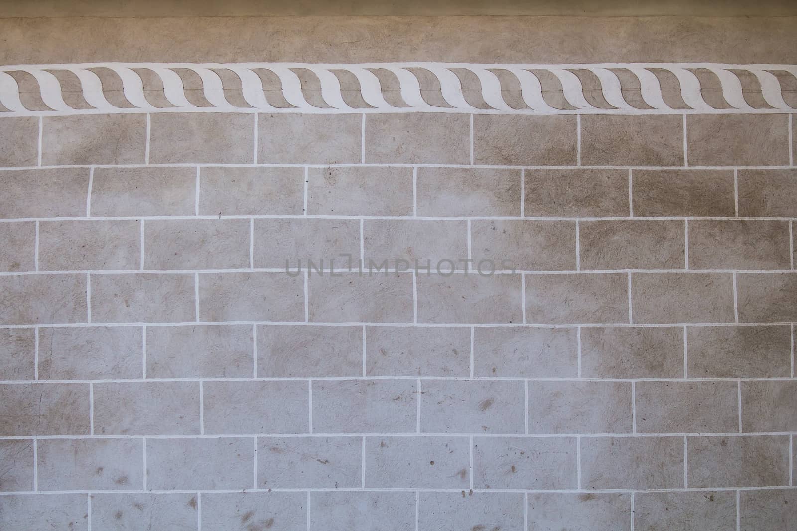 Grey-brown wall, original color of the facade and concrete, with contrast white texture and pattern in renaissance style.