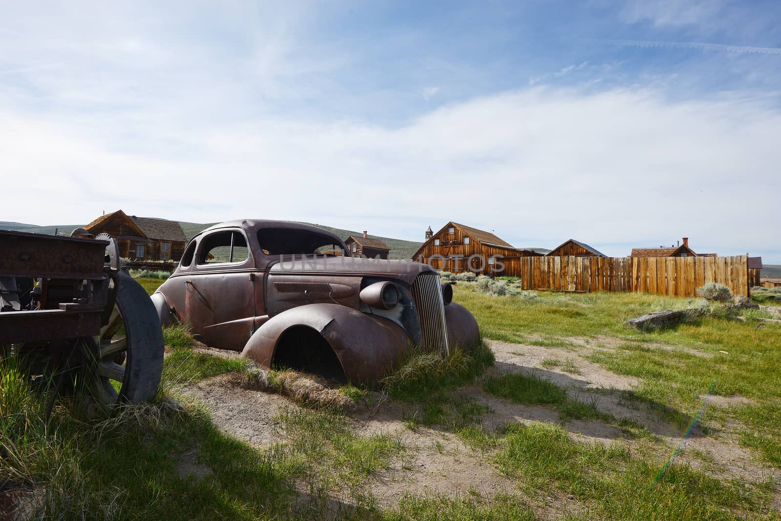 an old car in Bodie historic state park of a ghost town from a gold rush era in Sierra Nevada