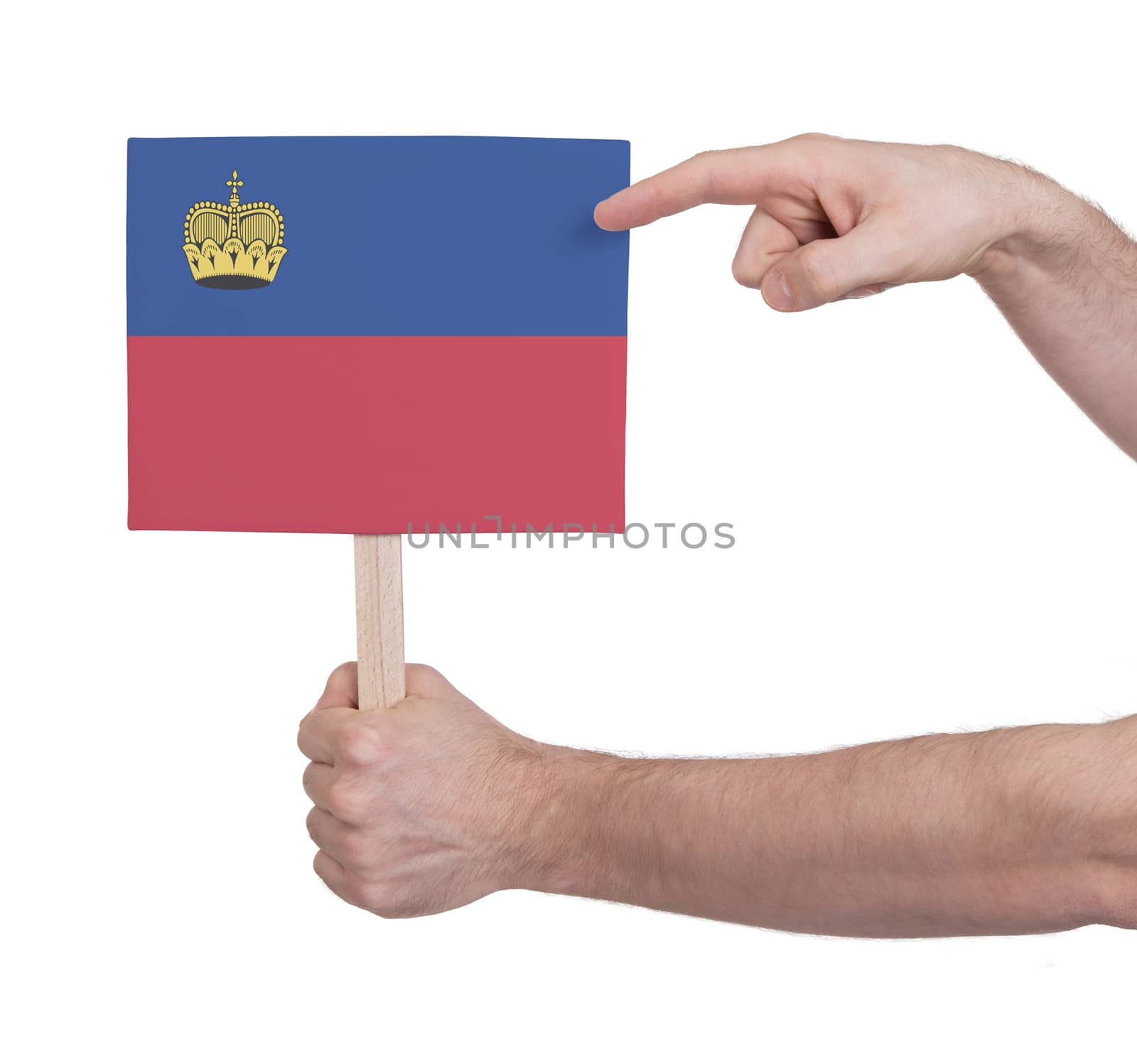 Hand holding small card, isolated on white - Flag of Liechtenstein