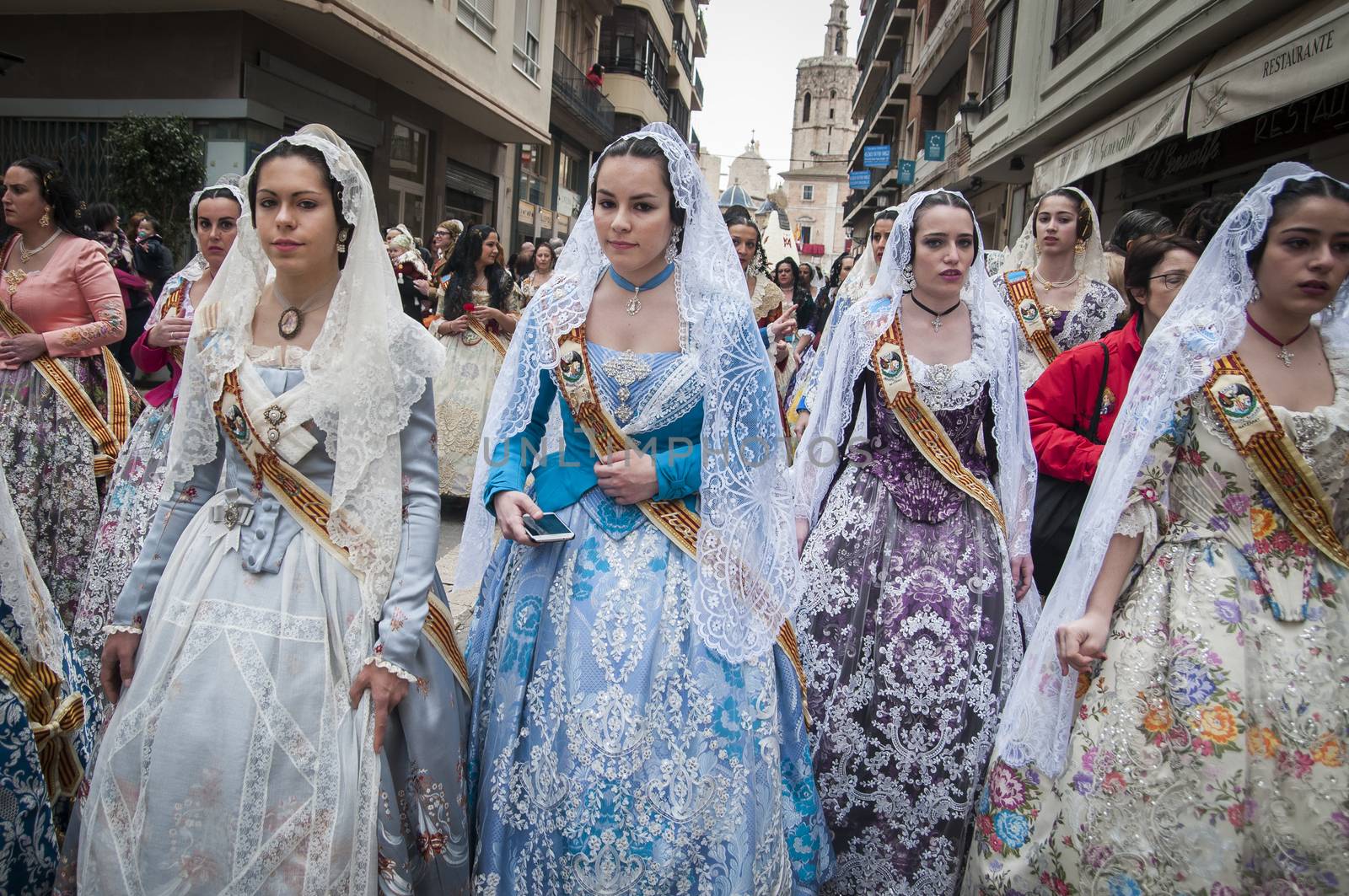SPAIN, Valencia: Members of different fallas associations (Casales Falleros) march in the streets in Valencia, Spain, on March 18, 2016, to take part in the offering of flowers to the disadvantaged Virgin, as part of the Fallas festival. Fallas are gigantic structures made of cardboard portraying current events and personalities in which individual figures. 