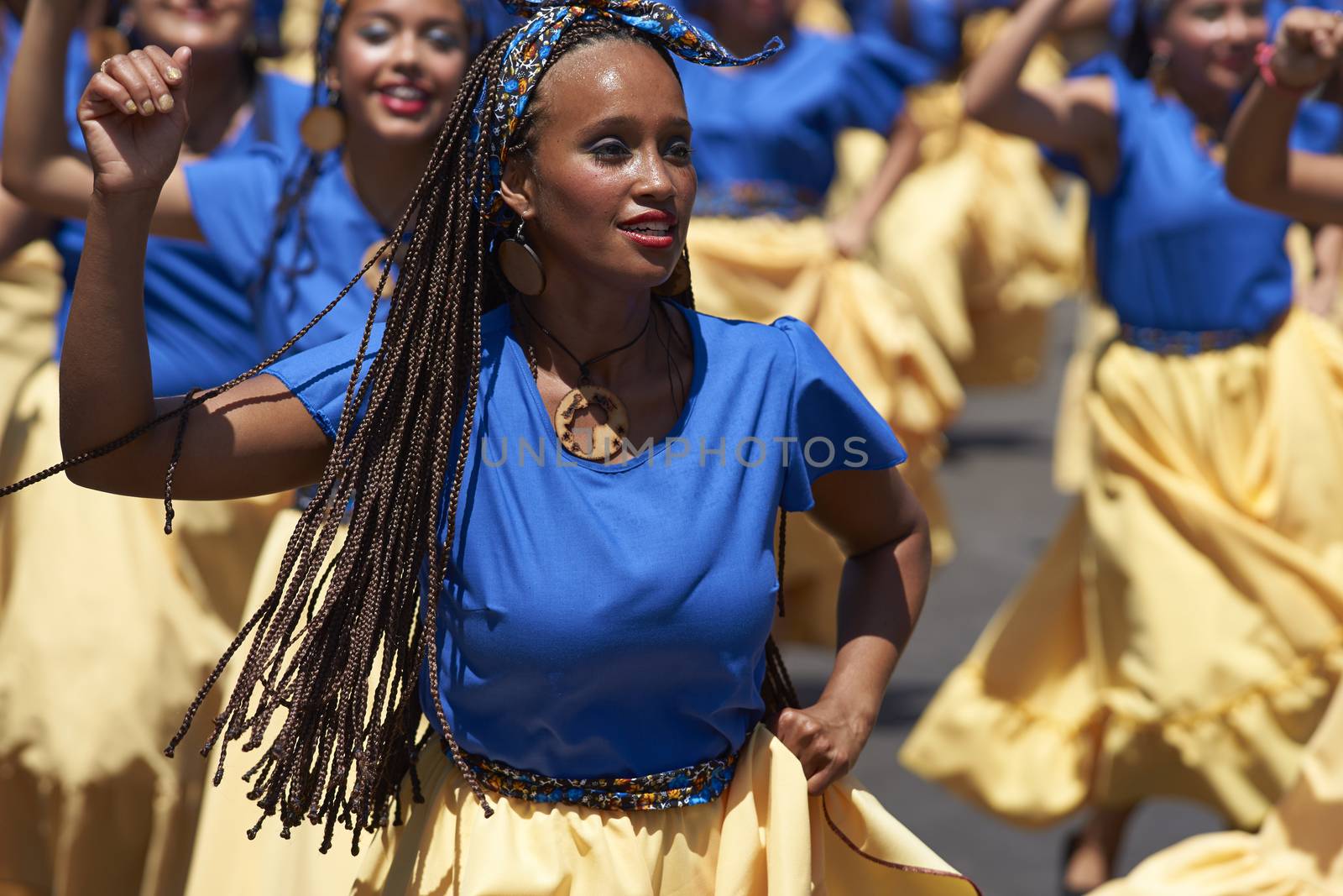 Group of dancers of Africa descent (Afrodescendiente) performing at the annual Carnaval Andino con la Fuerza del Sol in Arica, Chile.