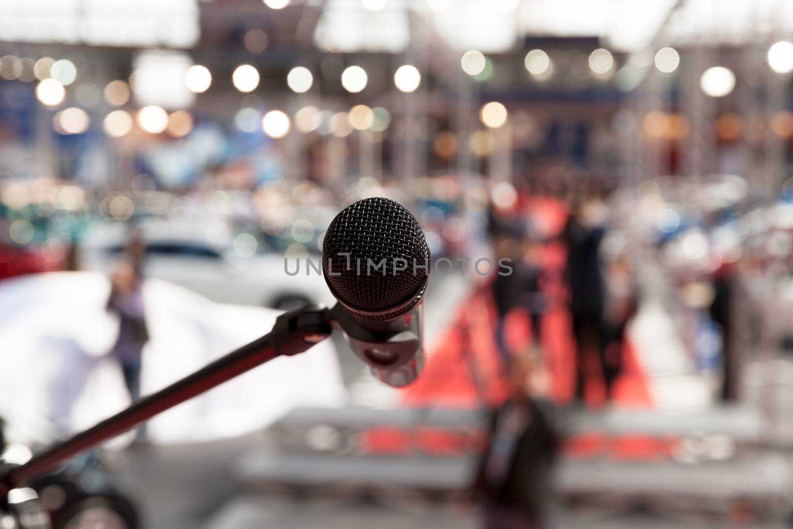 Microphone in focus against blurred audience