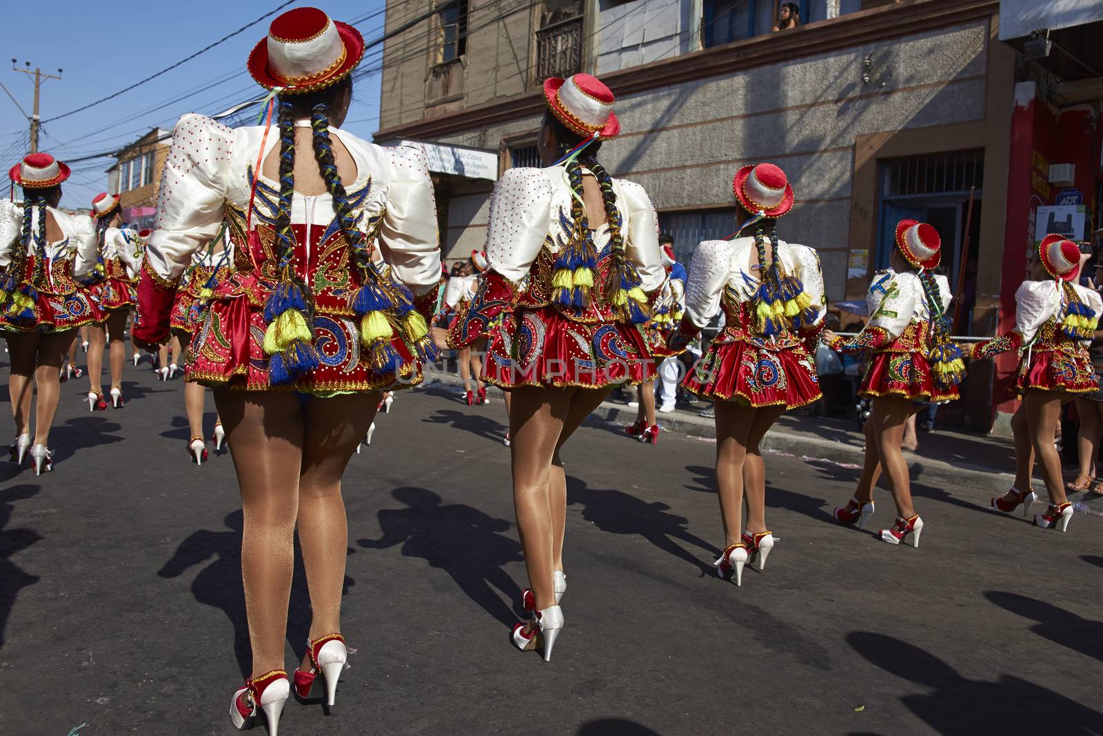 Caporales dancers in ornate costumes performing at the annual Carnaval Andino con la Fuerza del Sol in Arica, Chile.