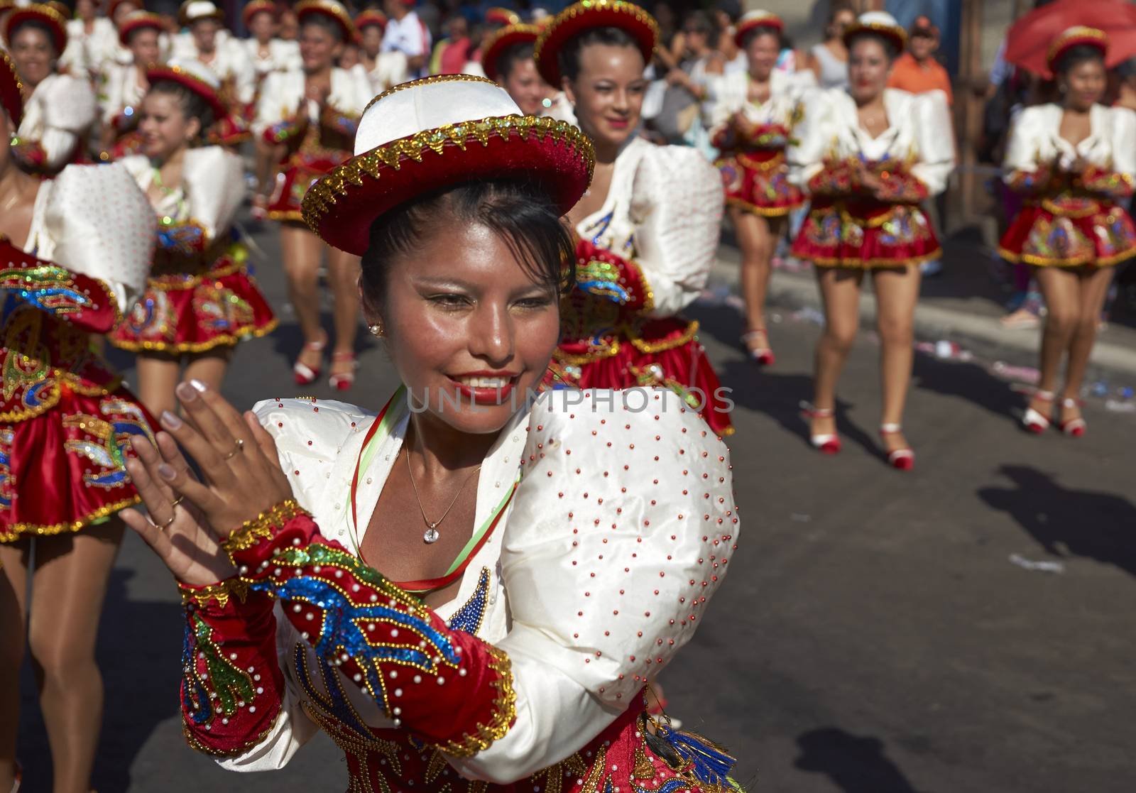 Caporales dancers in ornate costumes performing at the annual Carnaval Andino con la Fuerza del Sol in Arica, Chile.