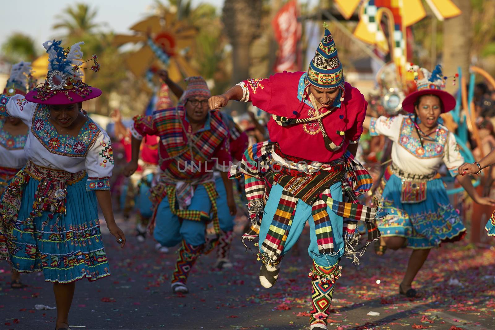 Tinku dancing group in colourful costumes performing a traditional ritual dance as part of the Carnaval Andino con la Fuerza del Sol in Arica, Chile.