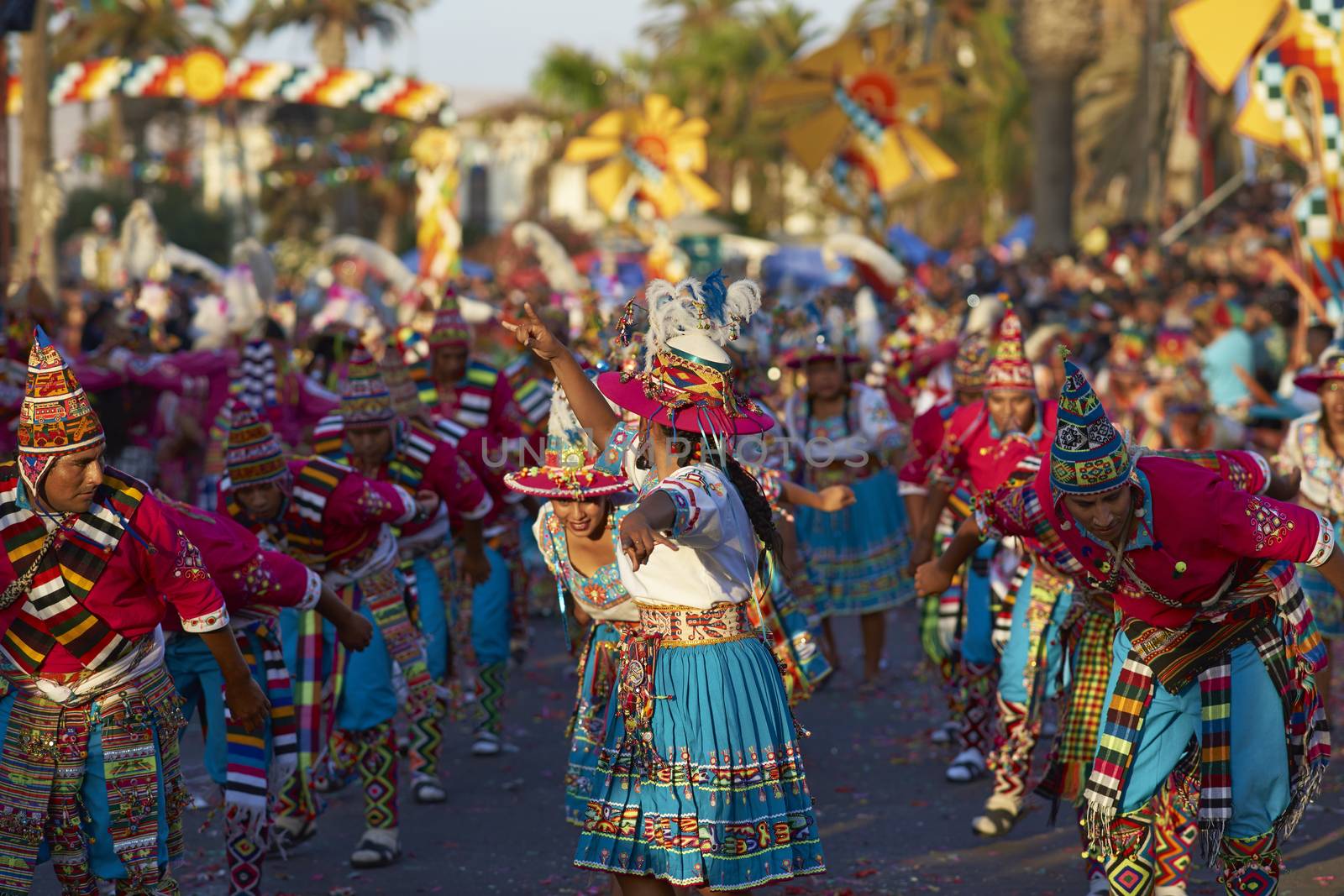 Tinku dancing group in colourful costumes performing a traditional ritual dance as part of the Carnaval Andino con la Fuerza del Sol in Arica, Chile.