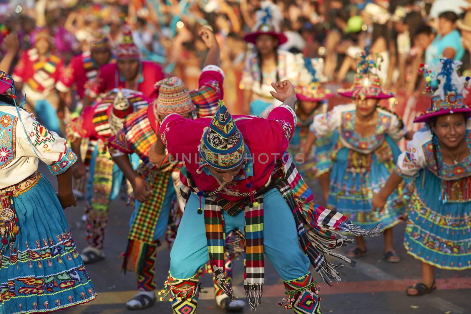 Tinku dancing group in colourful costumes performing a traditional ritual dance as part of the Carnaval Andino con la Fuerza del Sol in Arica, Chile.