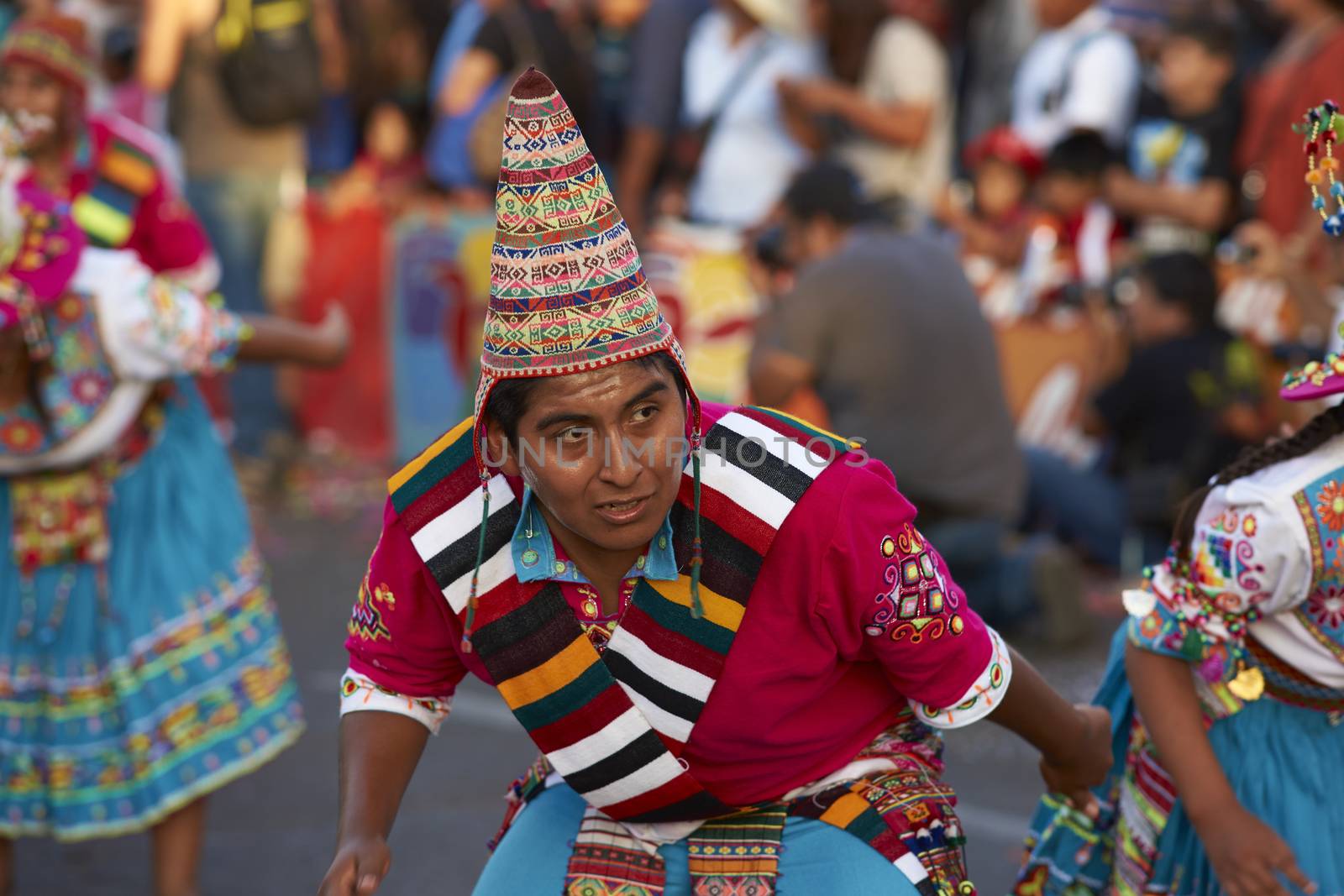 Tinku dancing group in colourful costumes performing a traditional ritual dance as part of the Carnaval Andino con la Fuerza del Sol in Arica, Chile.