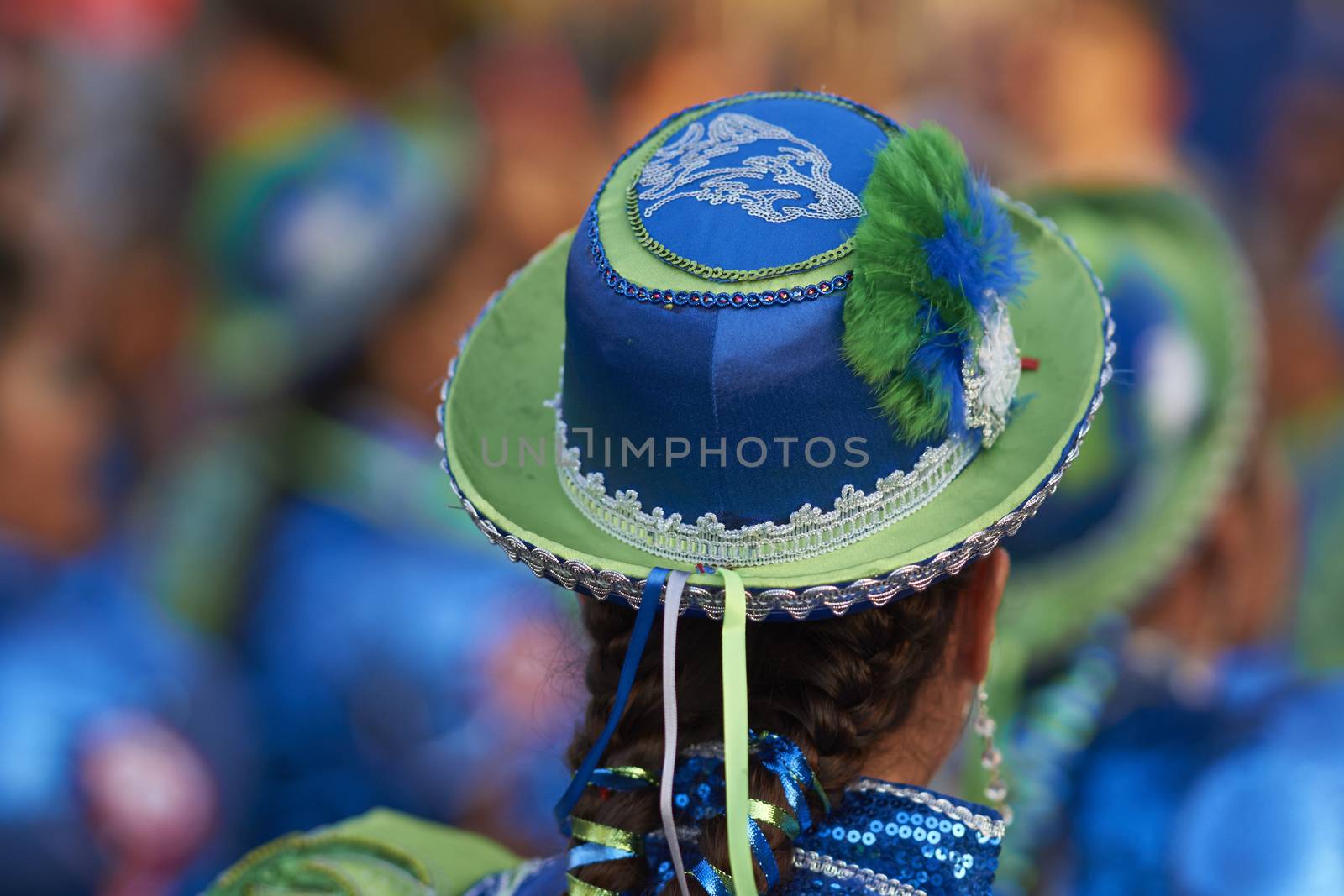 Caporales dancer in ornate blue and green costume performing at the annual Carnaval Andino con la Fuerza del Sol in Arica, Chile.