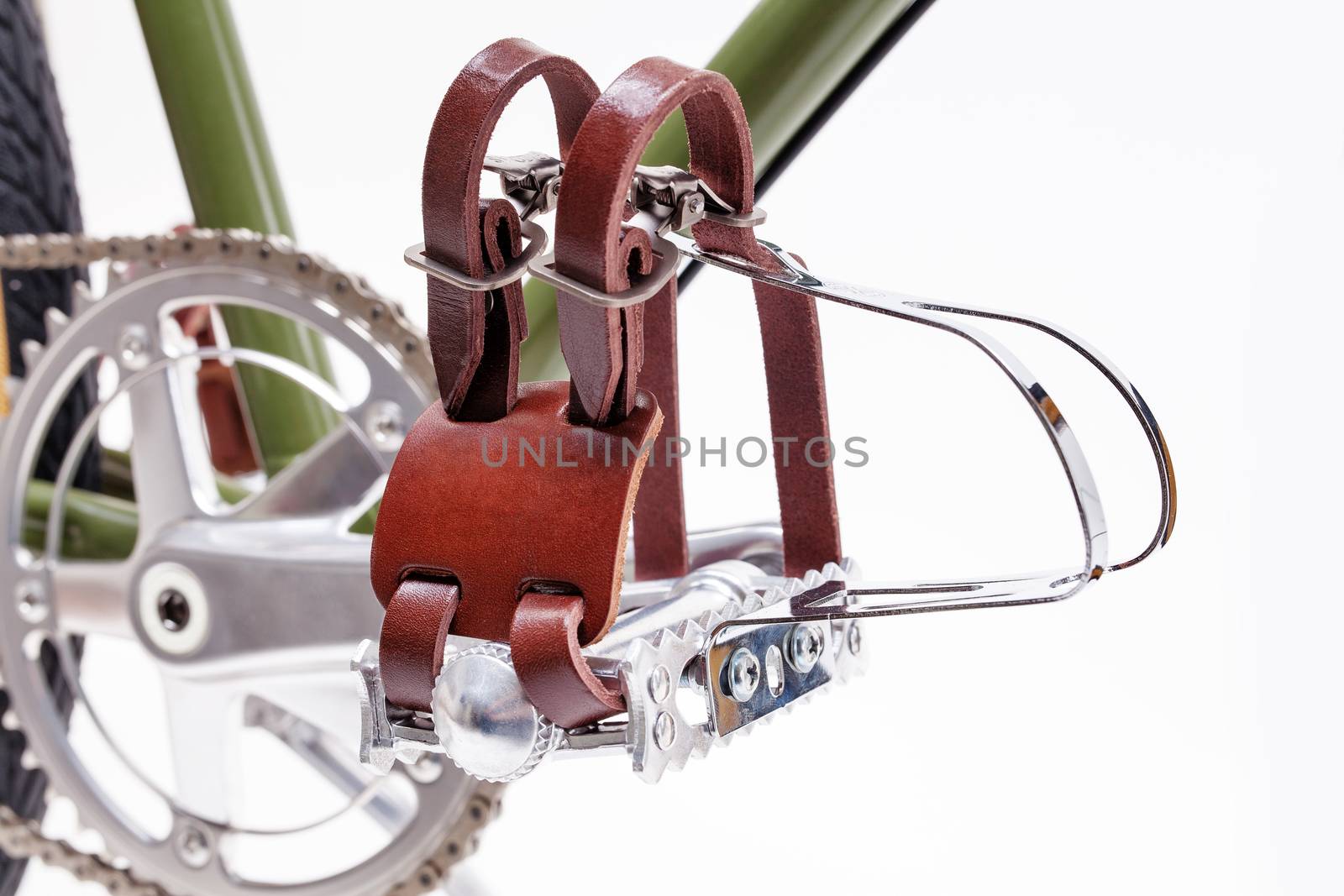 Vintage road bicycle pedals with toe clips isolated on white.