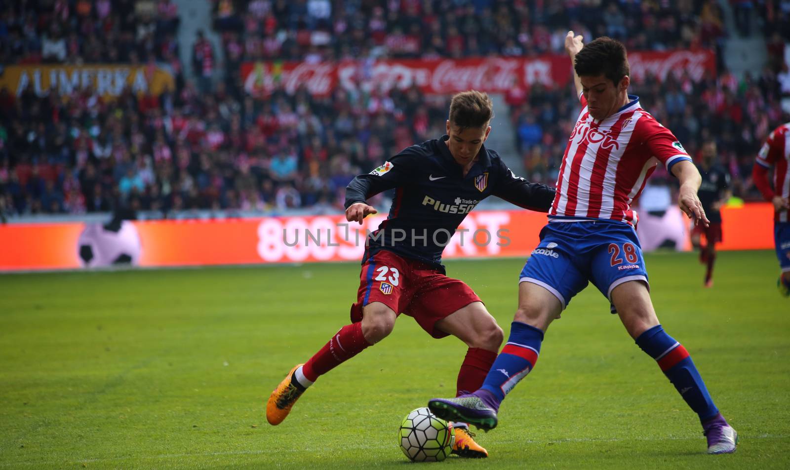 SPAIN, Gijon: Atletico de Madrid player Luciano Vietto fights for the possesion of the ball with Sporting de Gijon player Jorge Mere during the 30th day of the Liga BBVA football match between Sporting de Gijon and Atletico de Madrid in El Molinon Stadium, Gijon, Spain on March 19, 2016.
