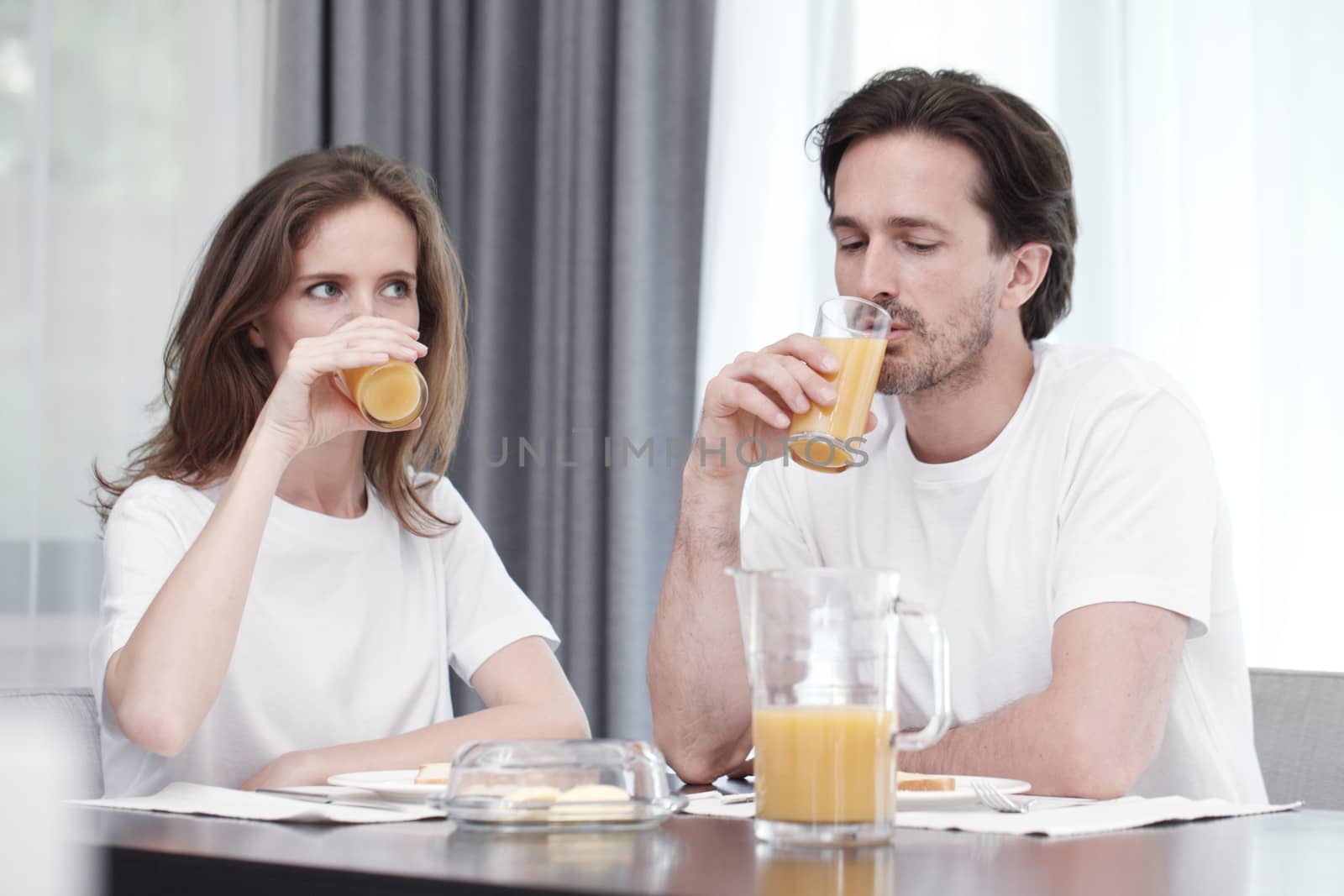 Couple having breakfast together at home 