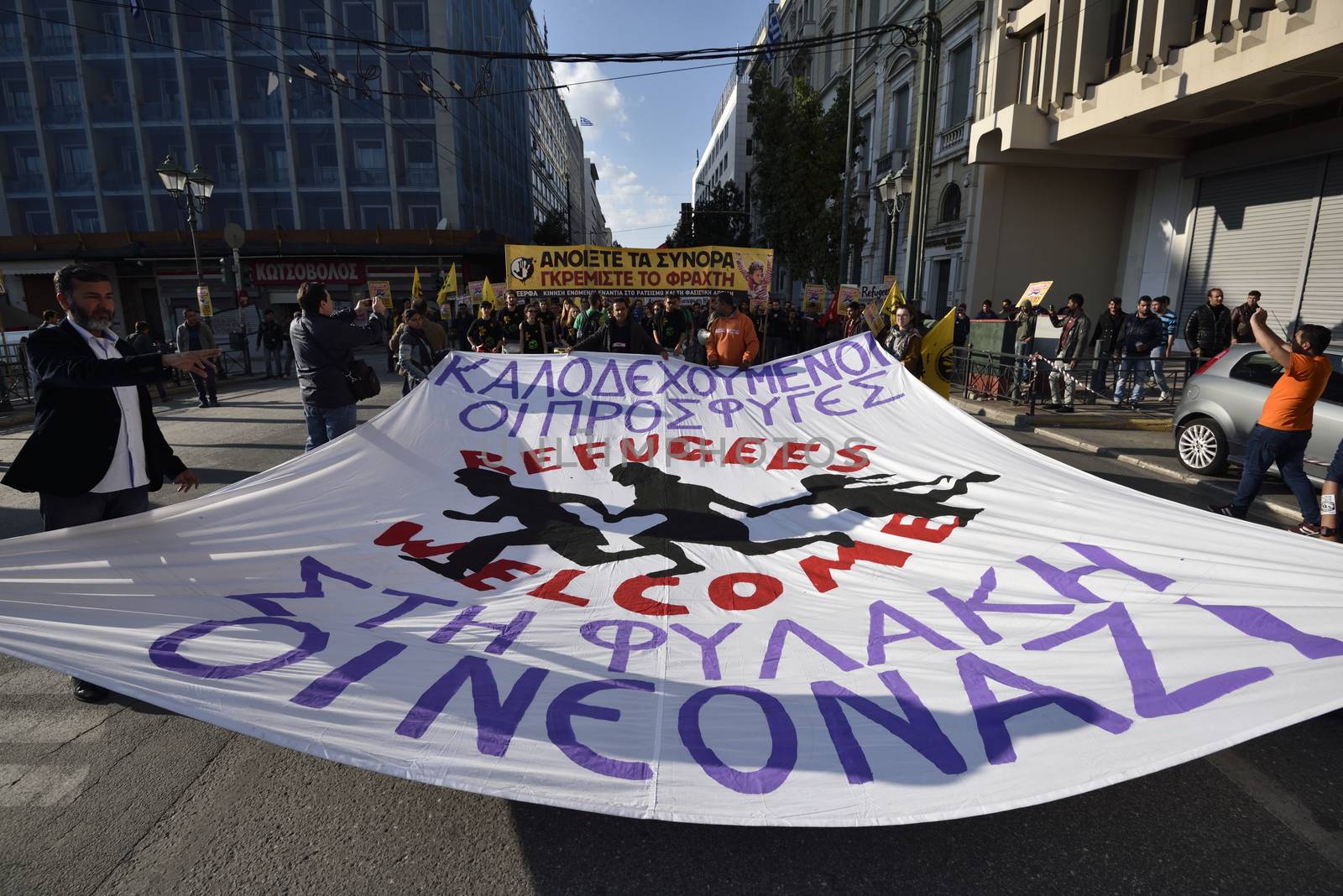 GREECE, Athens: Migrants march in central Athens holding a banner that reads Refugees welcome. Neo nazis to jail.Hundreds of migrants and supporters took part in a protest march in central Athens, condemning border fences and the NATO involvement in the refugee crisis on March 19, 2016.The protesters are calling for open borders to help the influx of migrants who are struggling in camps.