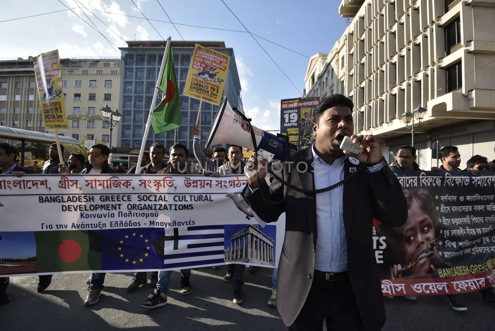 GREECE, Athens: Migrants march in central Athens holding banners and shouting slogans on March 19, 2016.Hundreds of migrants and supporters took part in a protest march in central Athens, condemning border fences and the NATO involvement in the refugee crisis. The protesters are calling for open borders to help the influx of migrants who are struggling in camps.