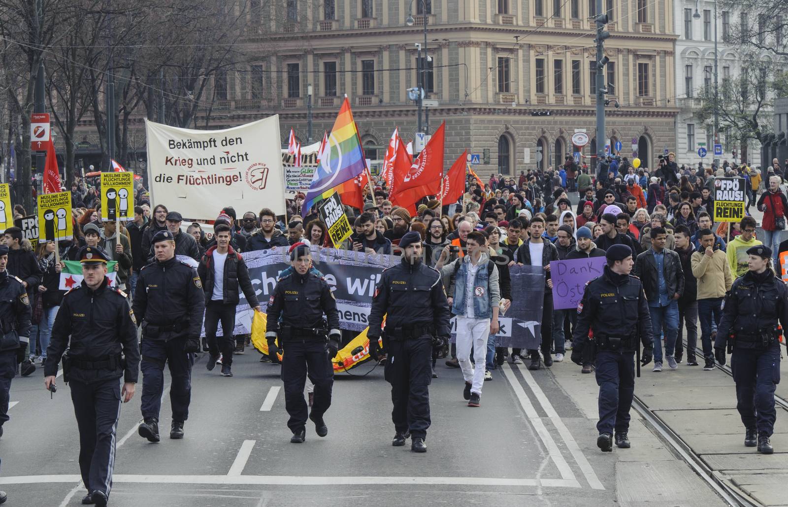 AUSTRIA, Vienna: Police walk out in front of the protest march keeping the peace on March 19, 2016 in Austria.The demonstrators have denounced 'fortress Europe' and demanded an end to racism. The demonstrators marched through Vienna, holding signs and waving flags.