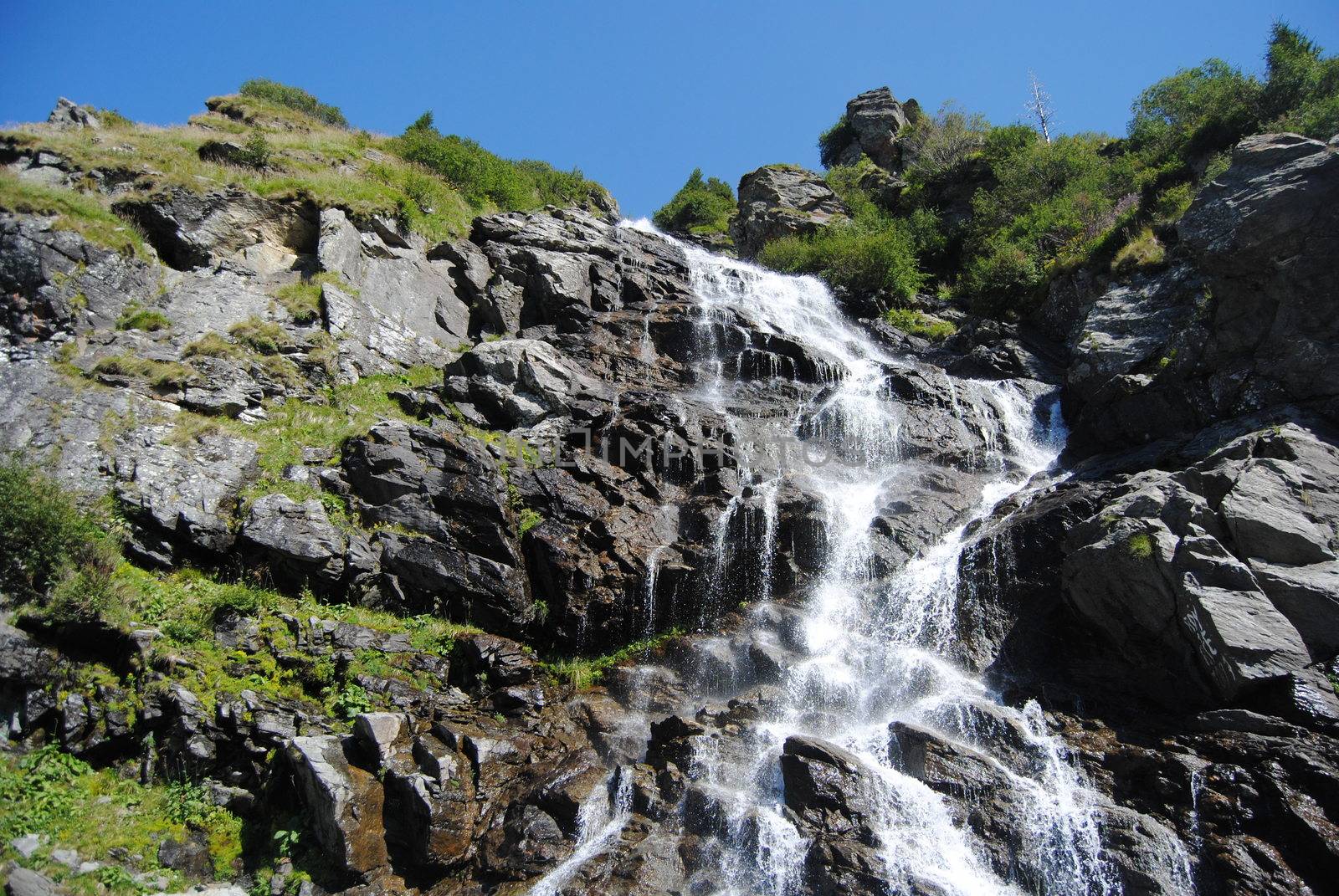 Waterfall near Transfagarasan, a famous road in Romania, crossing the mountains.