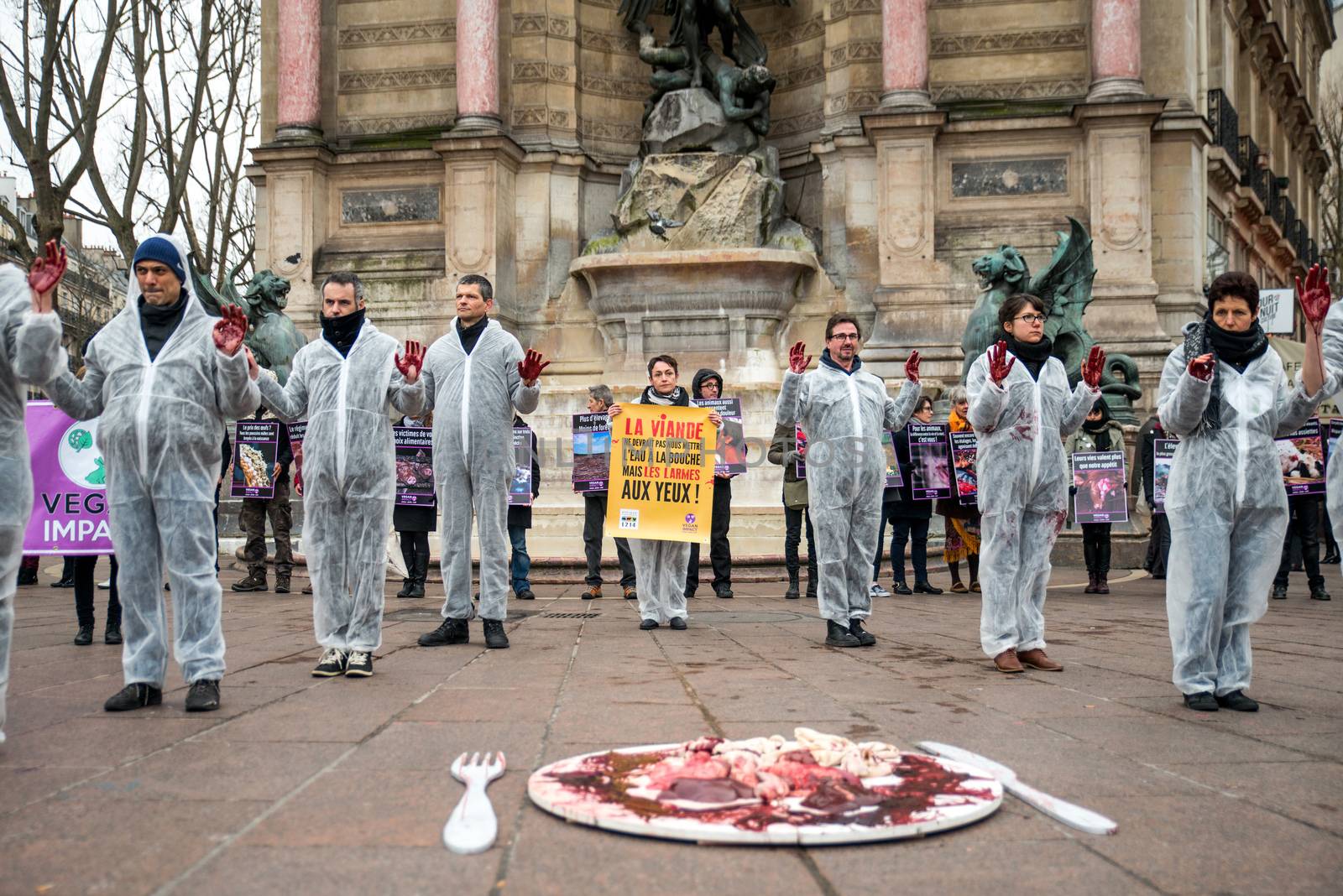 FRANCE, Paris: Members of the Vegan Impact association pose with bloody hands, during a demonstration commemorating International Day without Meat, at Saint-Michel square in Paris, on March 19, 2016.