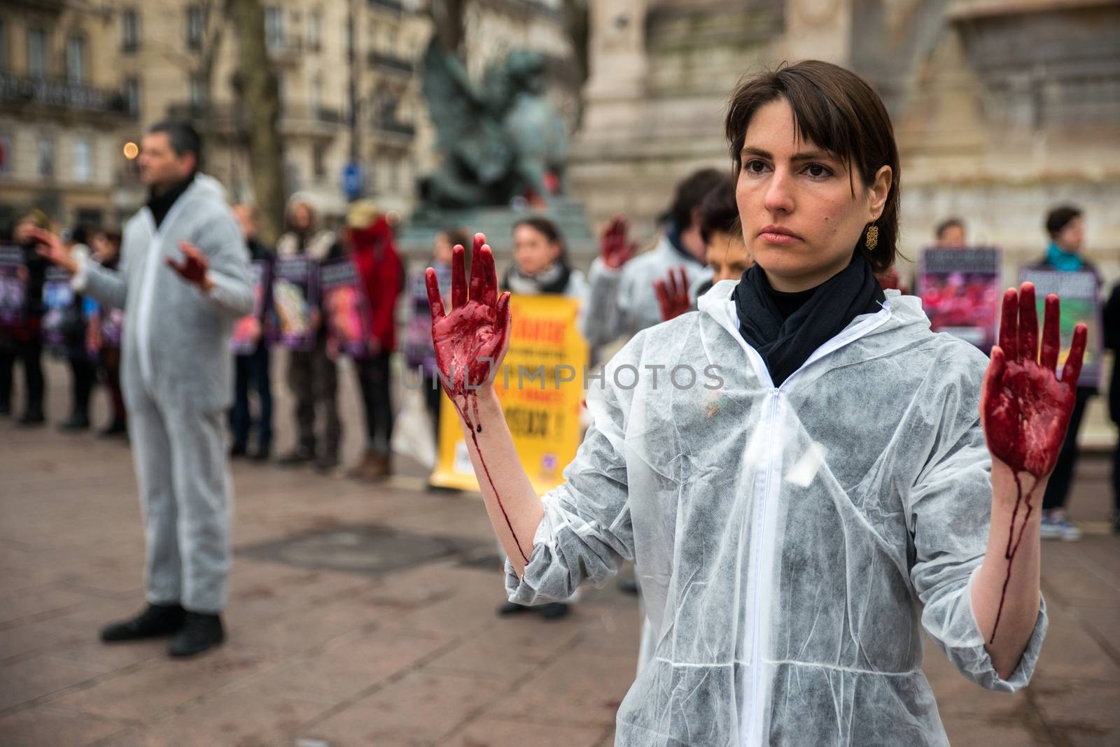 FRANCE, Paris: A member of the Vegan Impact association poses with bloody hands, during a demonstration commemorating International Day without Meat, at Saint-Michel square in Paris, on March 19, 2016.
