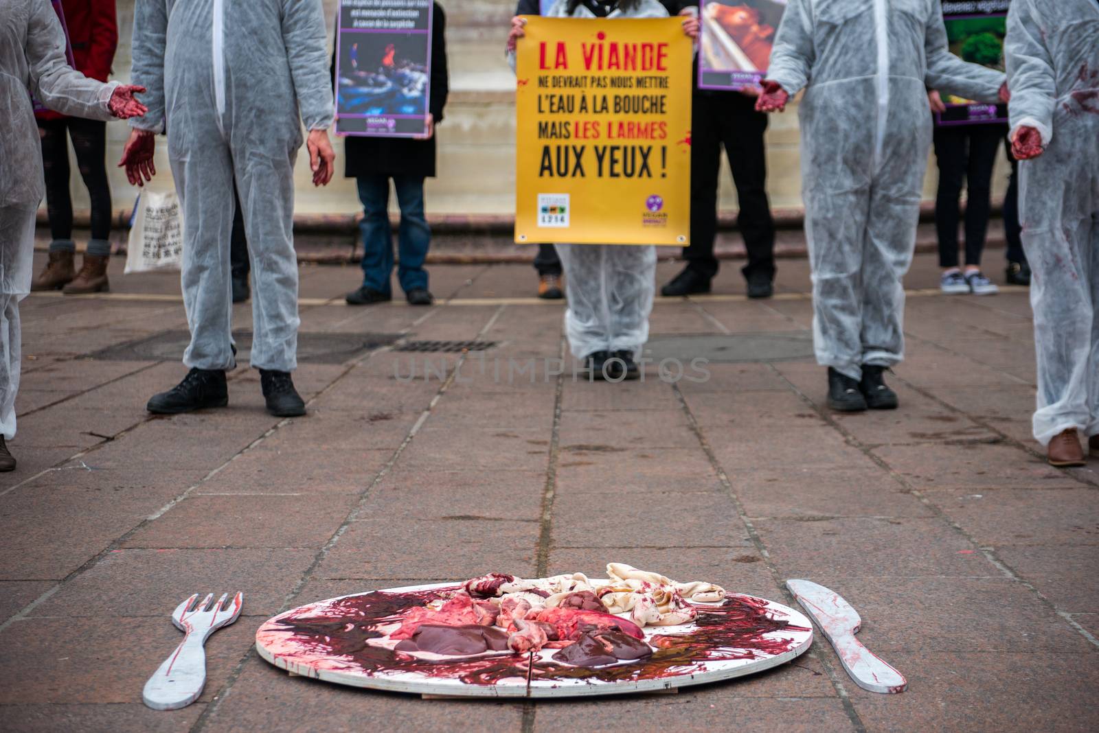 FRANCE, Paris: Members of the Vegan Impact association pose with bloody hands, during a demonstration commemorating International Day without Meat, at Saint-Michel square in Paris, on March 19, 2016.