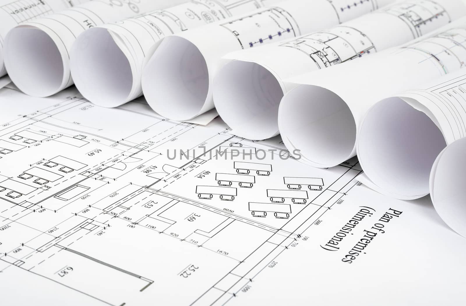 Blueprints and rolls of blueprints, side view. Building concept