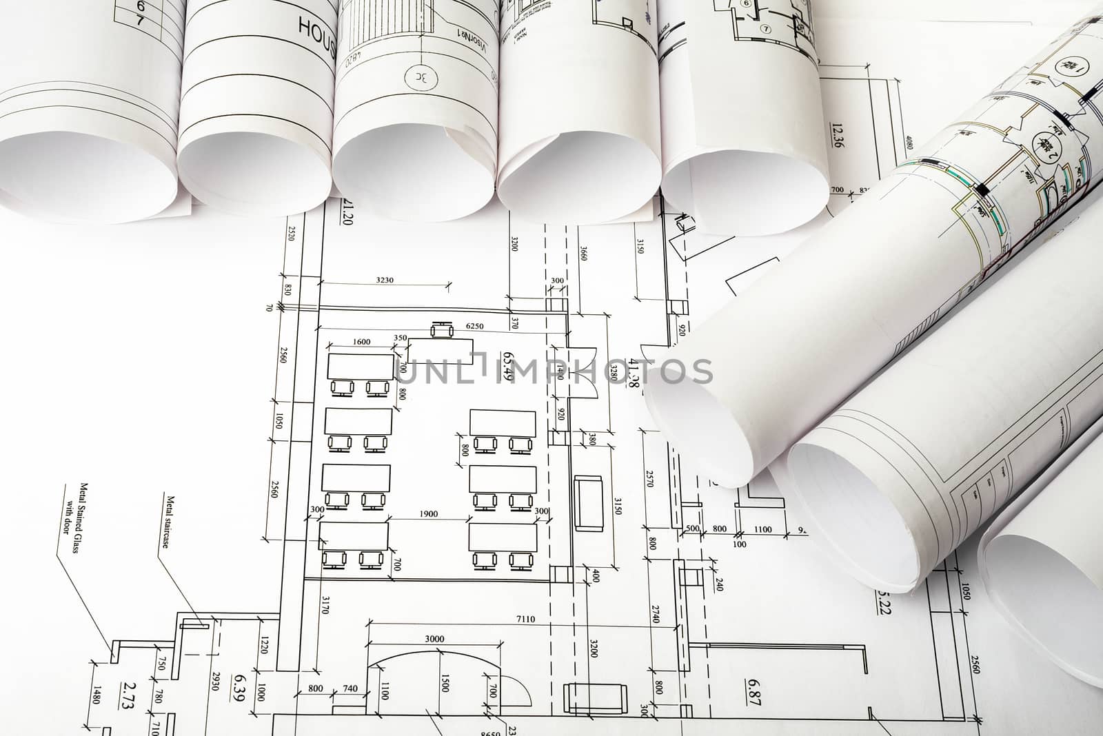 Blueprints and rolls of blueprints, top view. Building concept