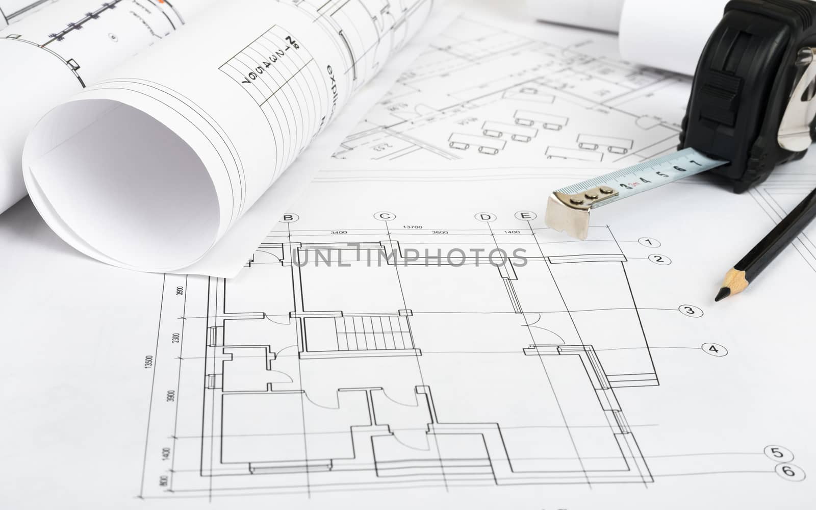 Architecture plan and rolls of blueprints with meter. Building concept