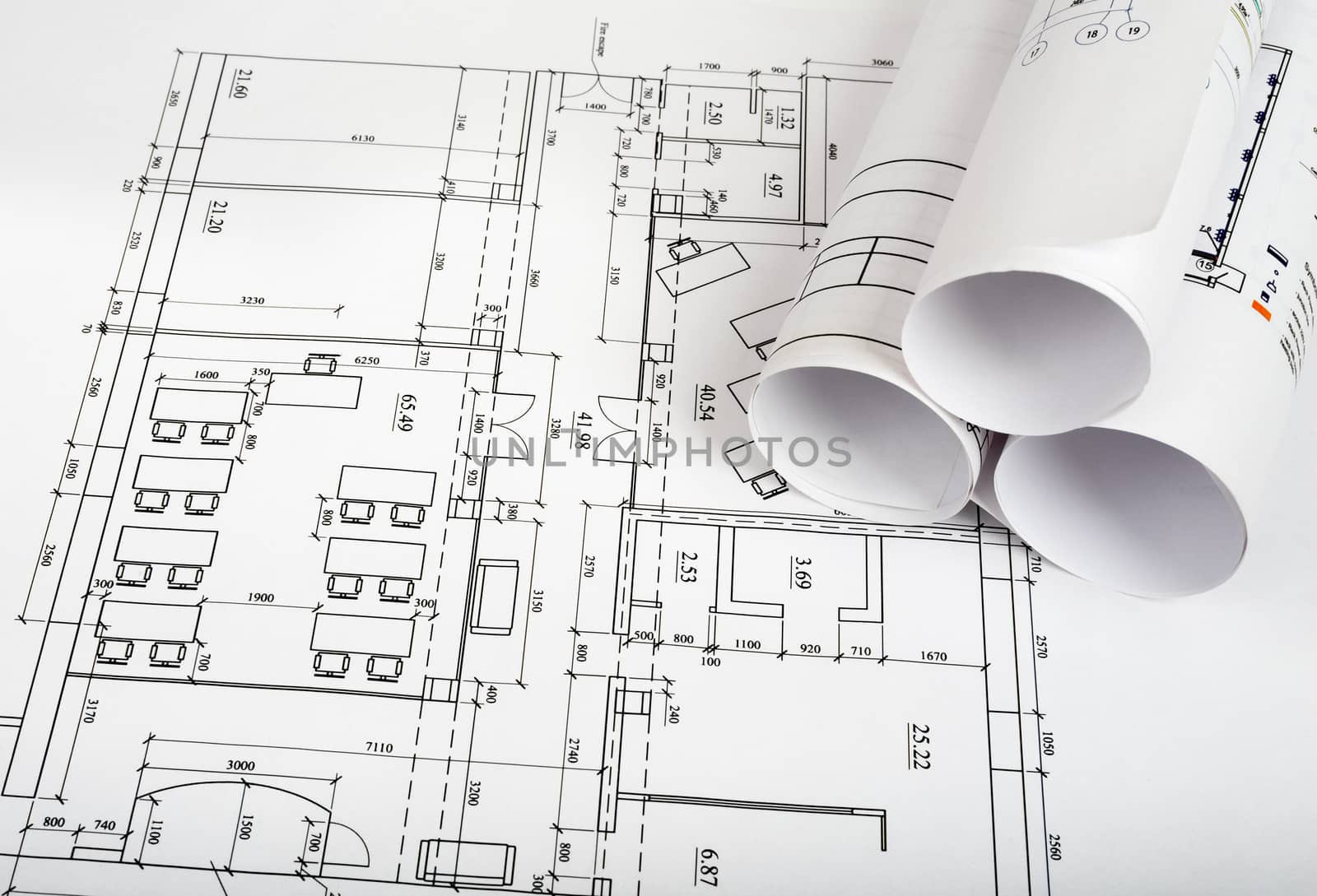 Blueprints and rolls of blueprints, side view. Building concept