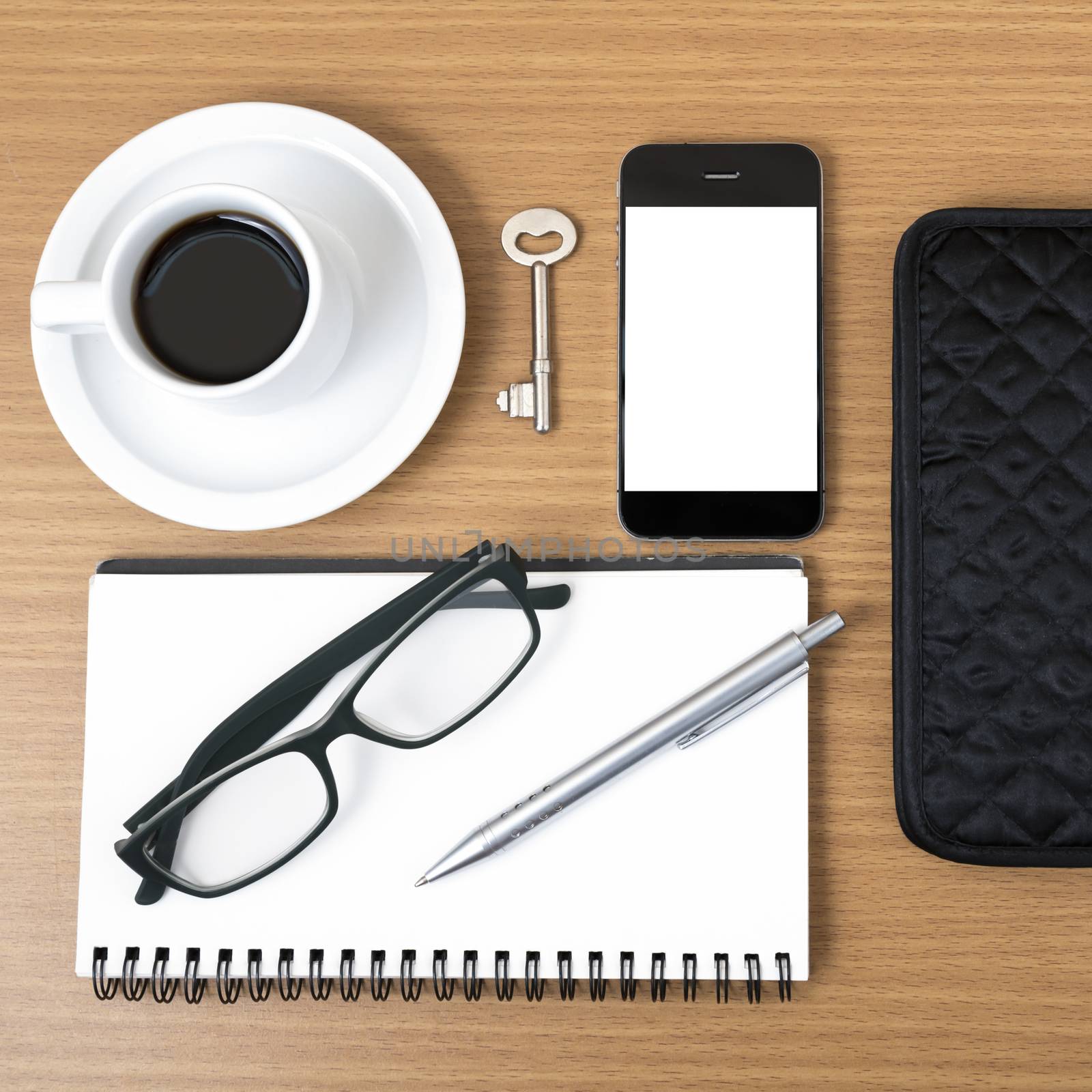 coffee and phone with notepad,key,eyeglasses and wallet on wood table background