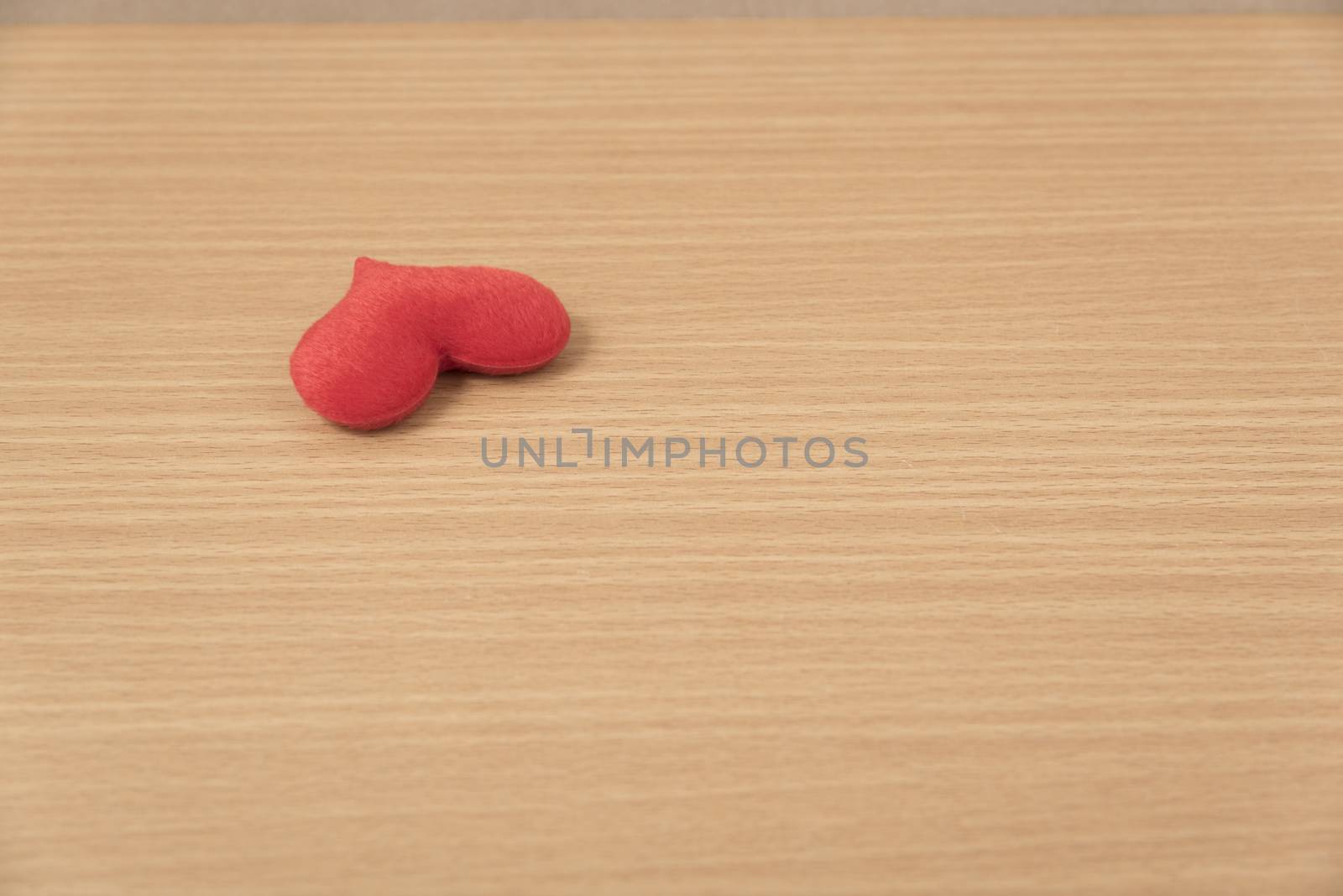 red heart on wood table background