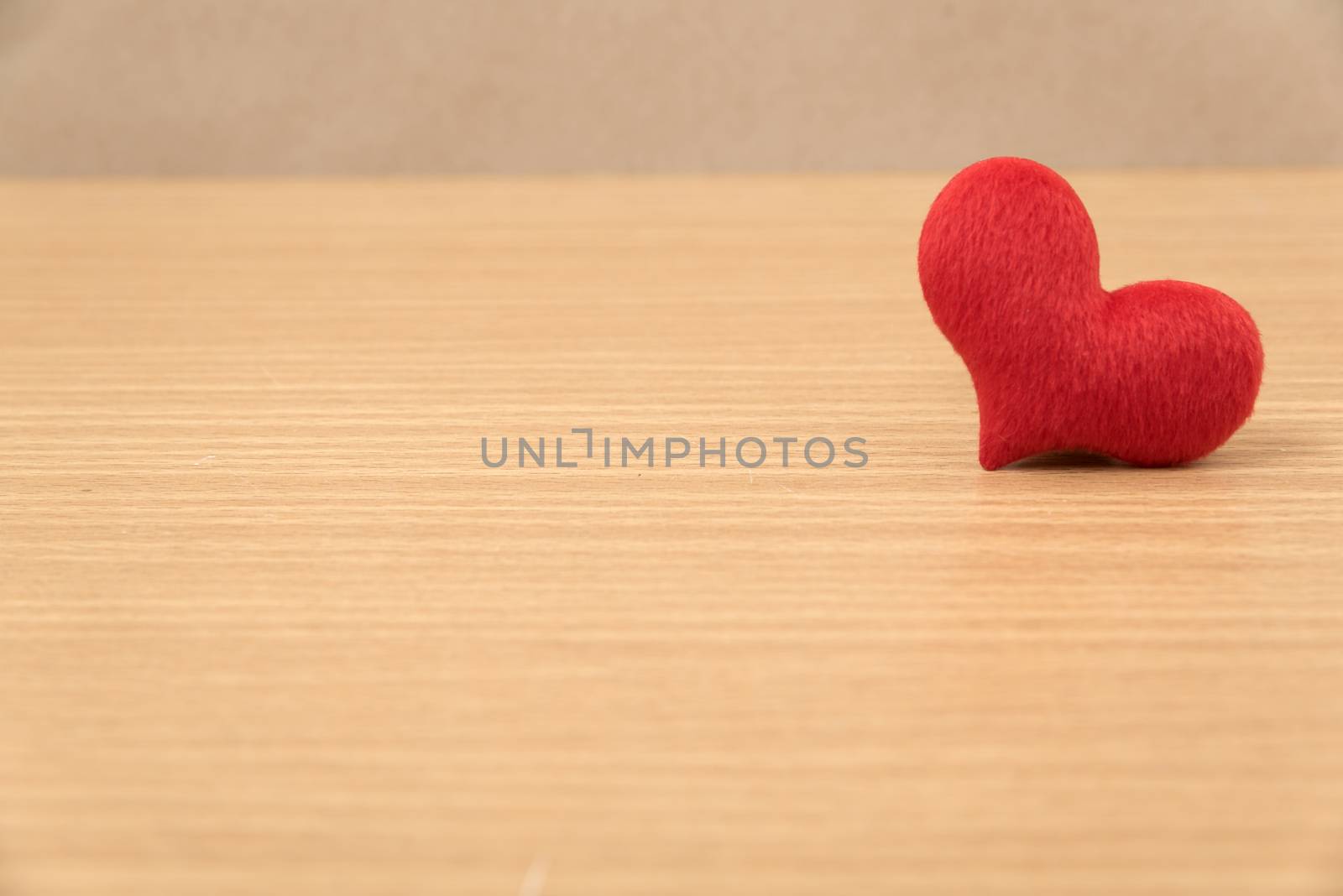 red heart on wood table background