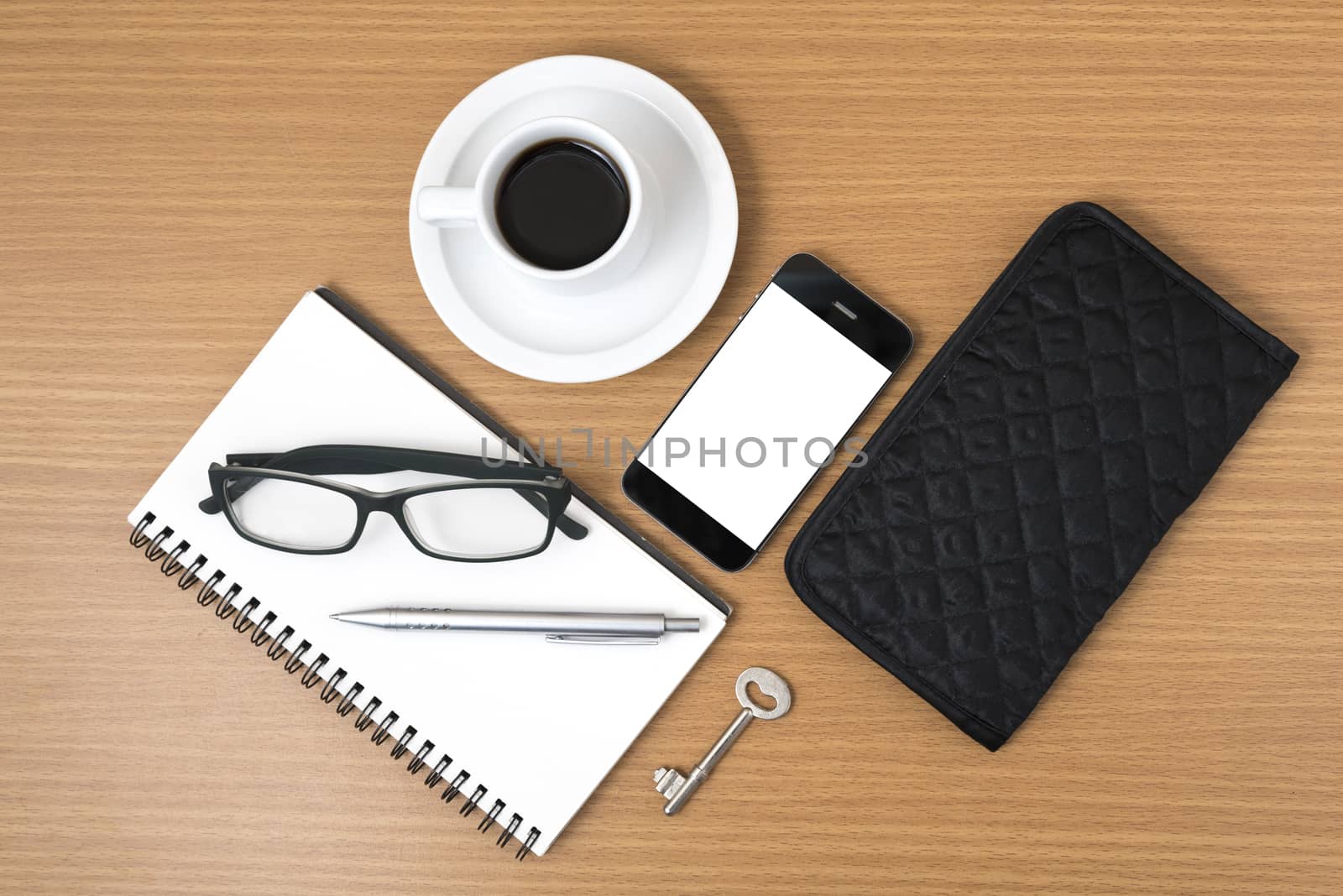 coffee and phone with notepad,key,eyeglasses and wallet on wood table background