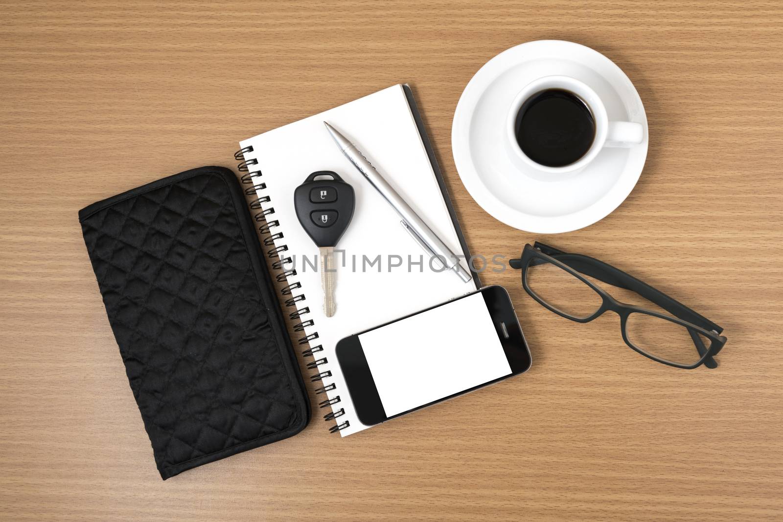 coffee and phone with notepad,car key,eyeglasses and wallet on wood table background