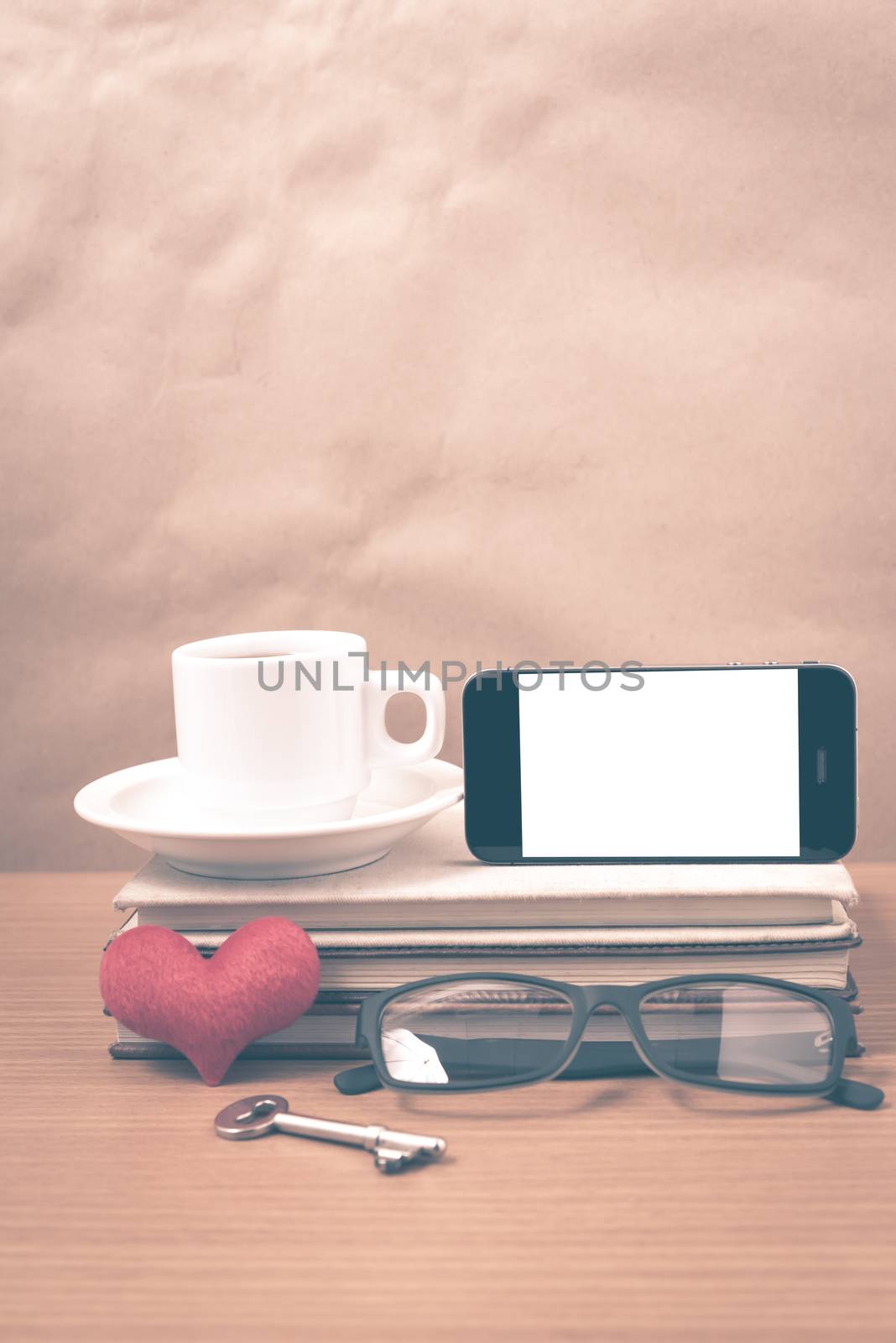 office desk : coffee and phone with key,eyeglasses,stack of book by ammza12