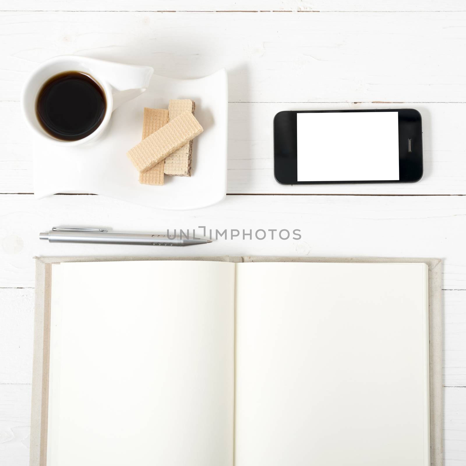 coffee cup with wafer,phone,notebook on white wood background