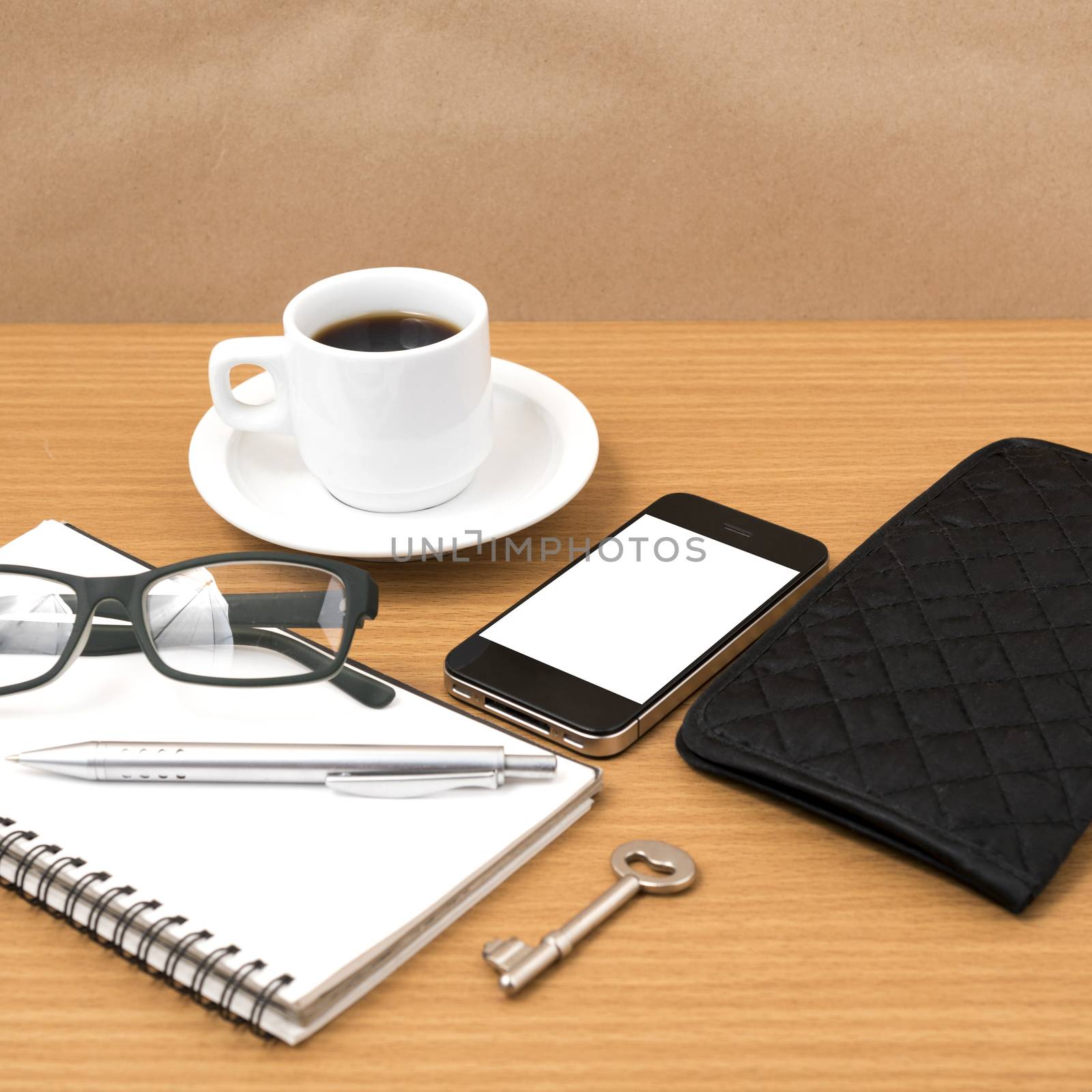 coffee and phone with notepad,key,eyeglasses and wallet on wood table background