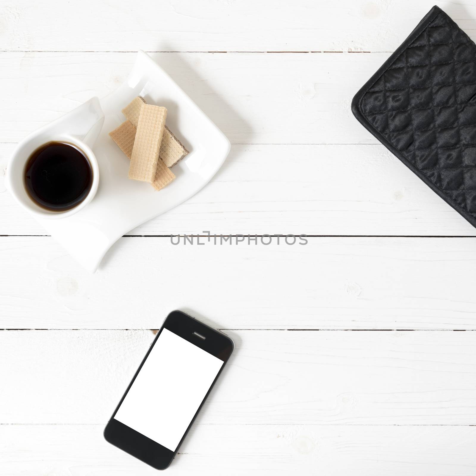 coffee cup with wafer,phone,wallet on white wood background