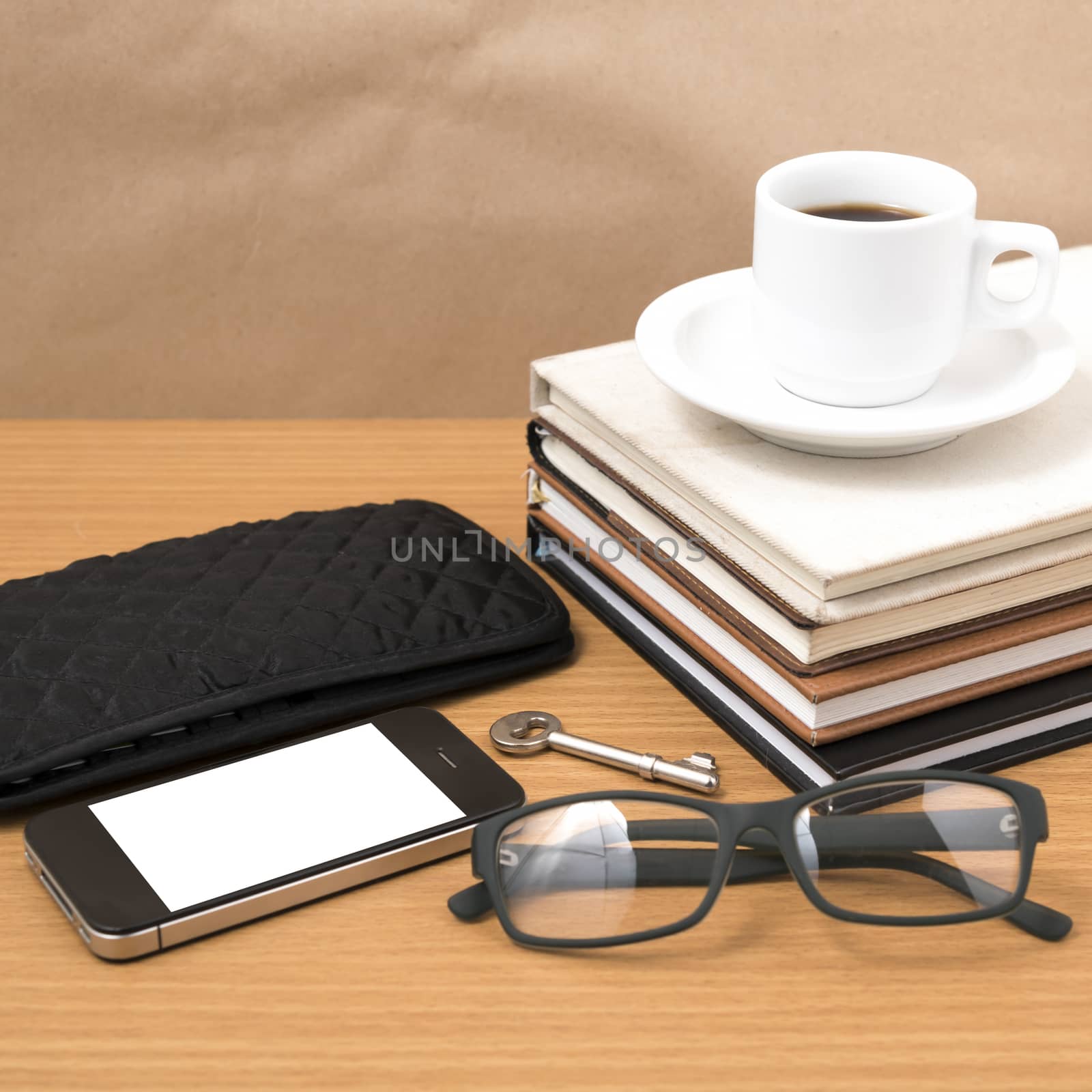 coffee and phone with stack of book,key,eyeglasses and wallet on wood background