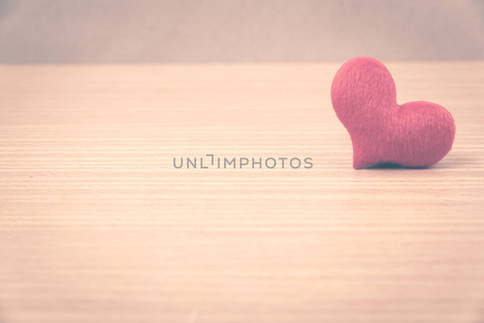 red heart on wood table background vintage style
