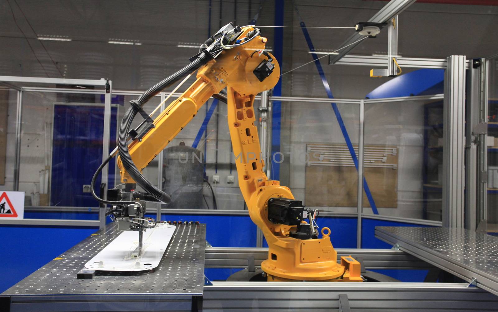 Industrial robotic arm in electronics production line 