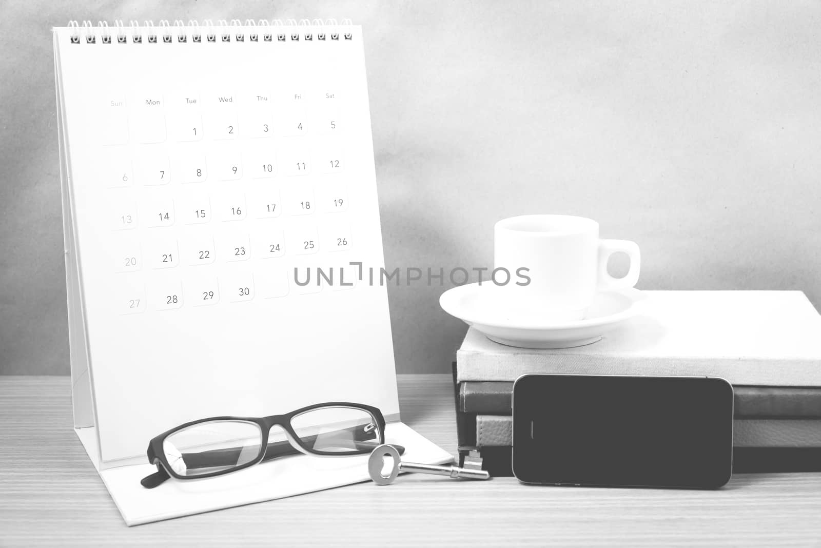 coffee and phone with key,eyeglasses,stack of book,calendar blac by ammza12