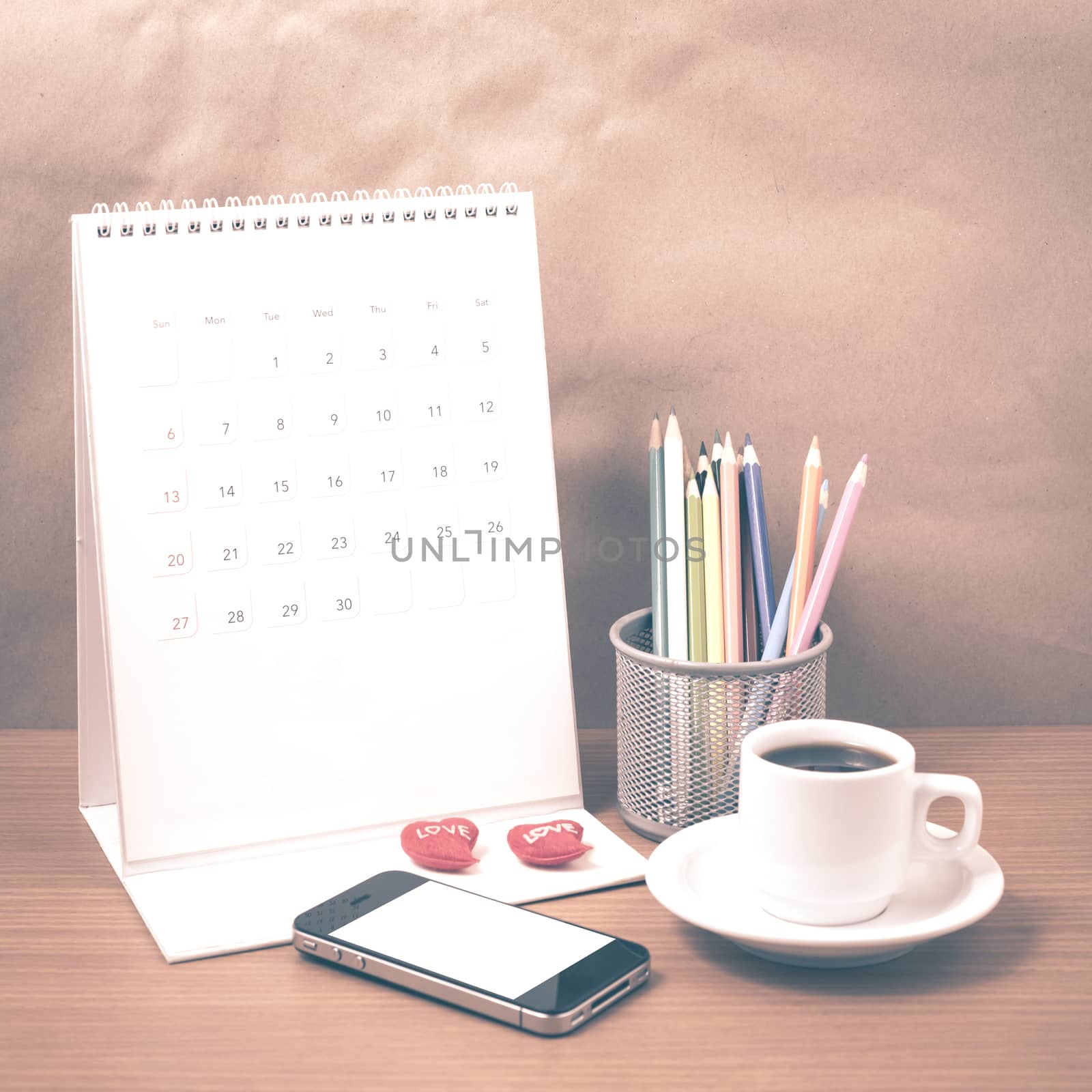 office desk : coffee with phone,calendar,heart,color pencil on wood background vintage style